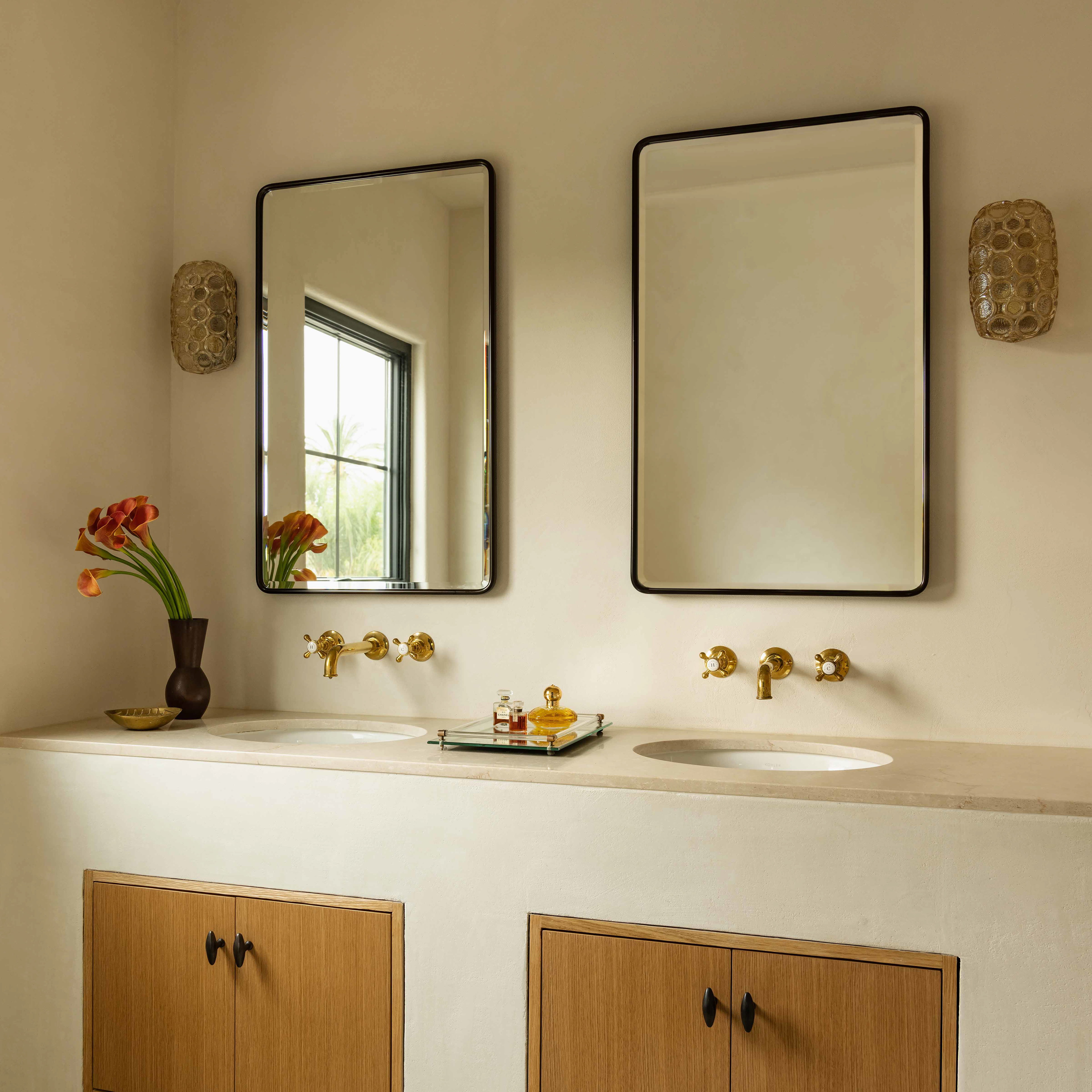 a bathroom with two sinks and a mirror