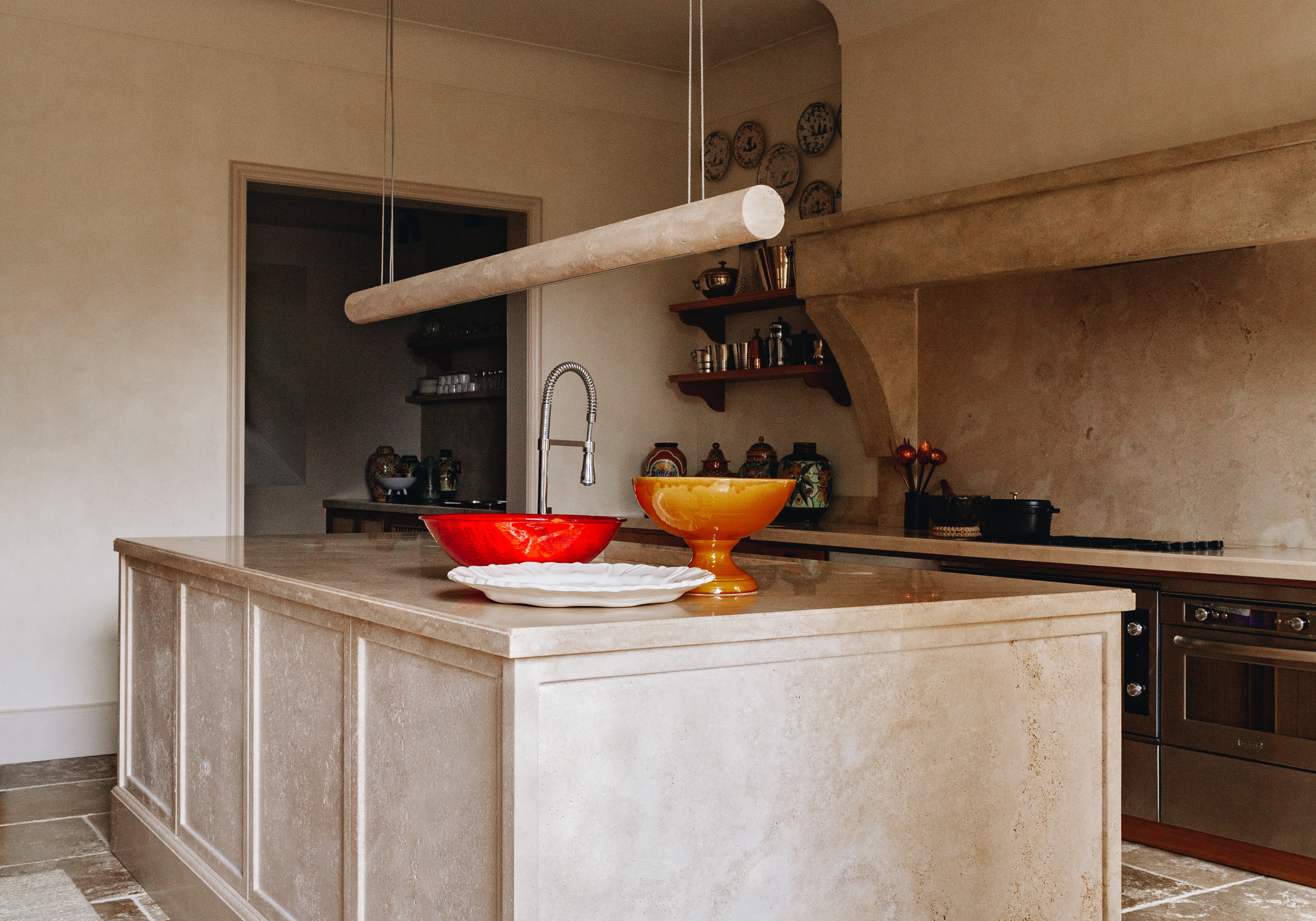 a kitchen with a sink, stove and a counter