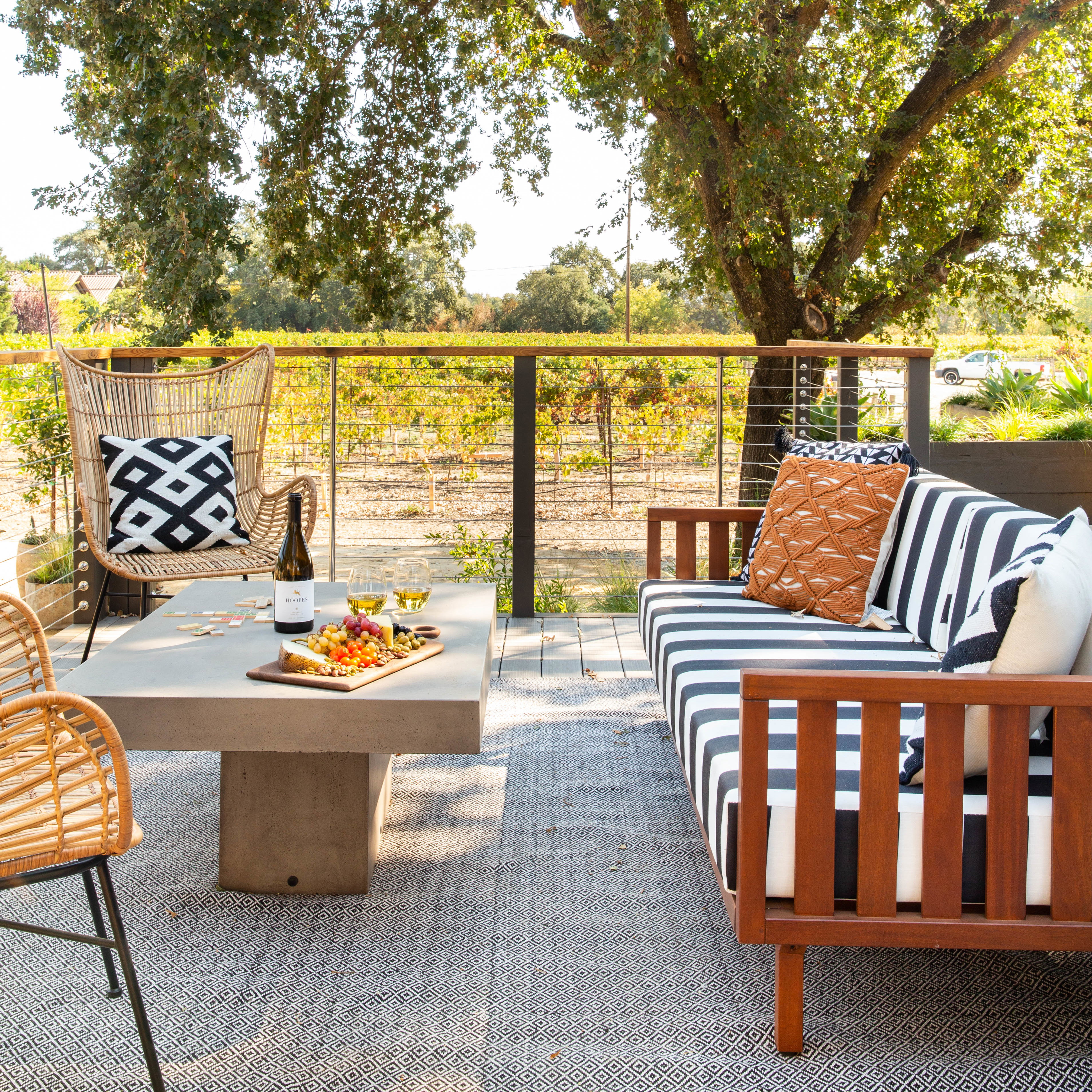 a patio with a table, chairs, and a couch