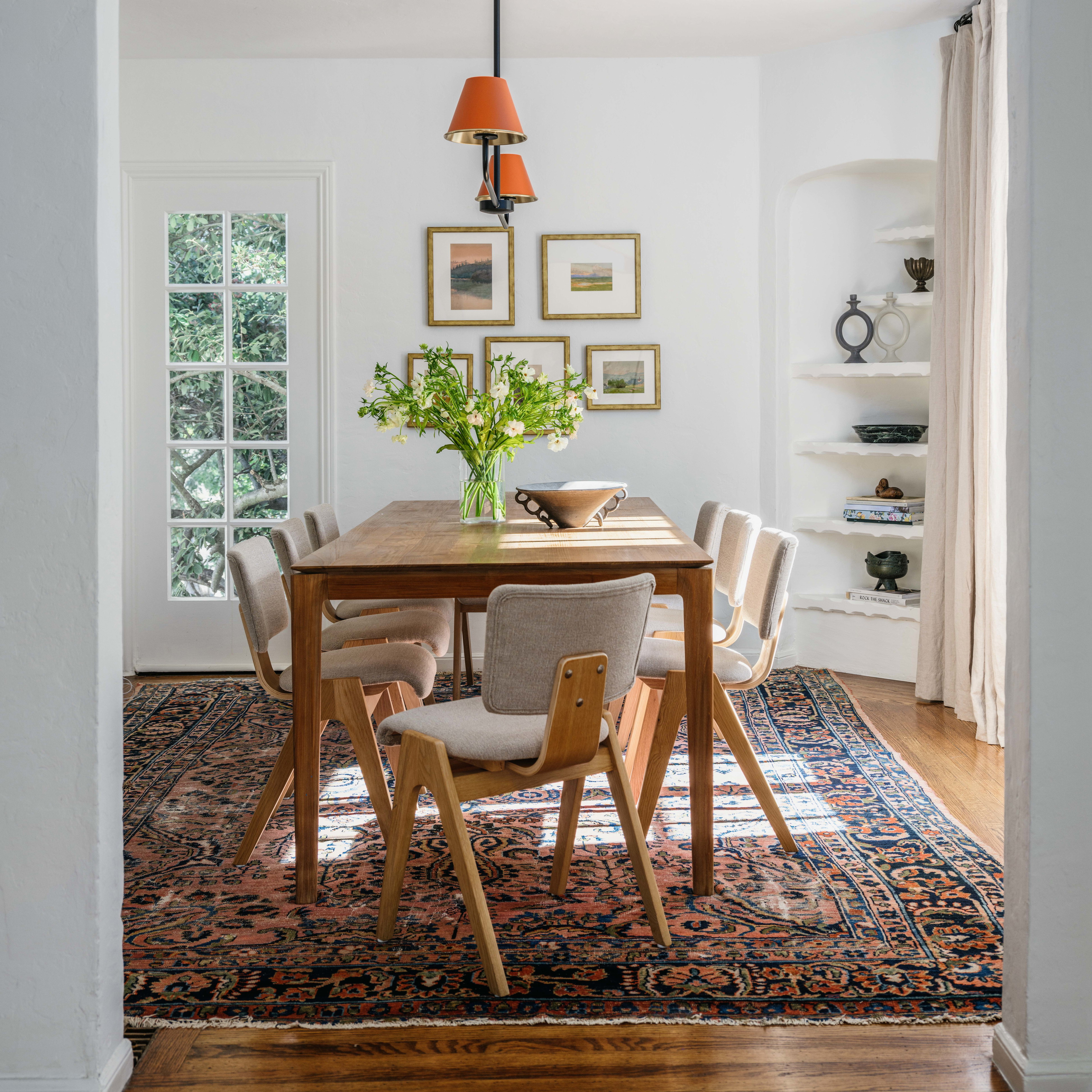 a dining room with a table and chairs