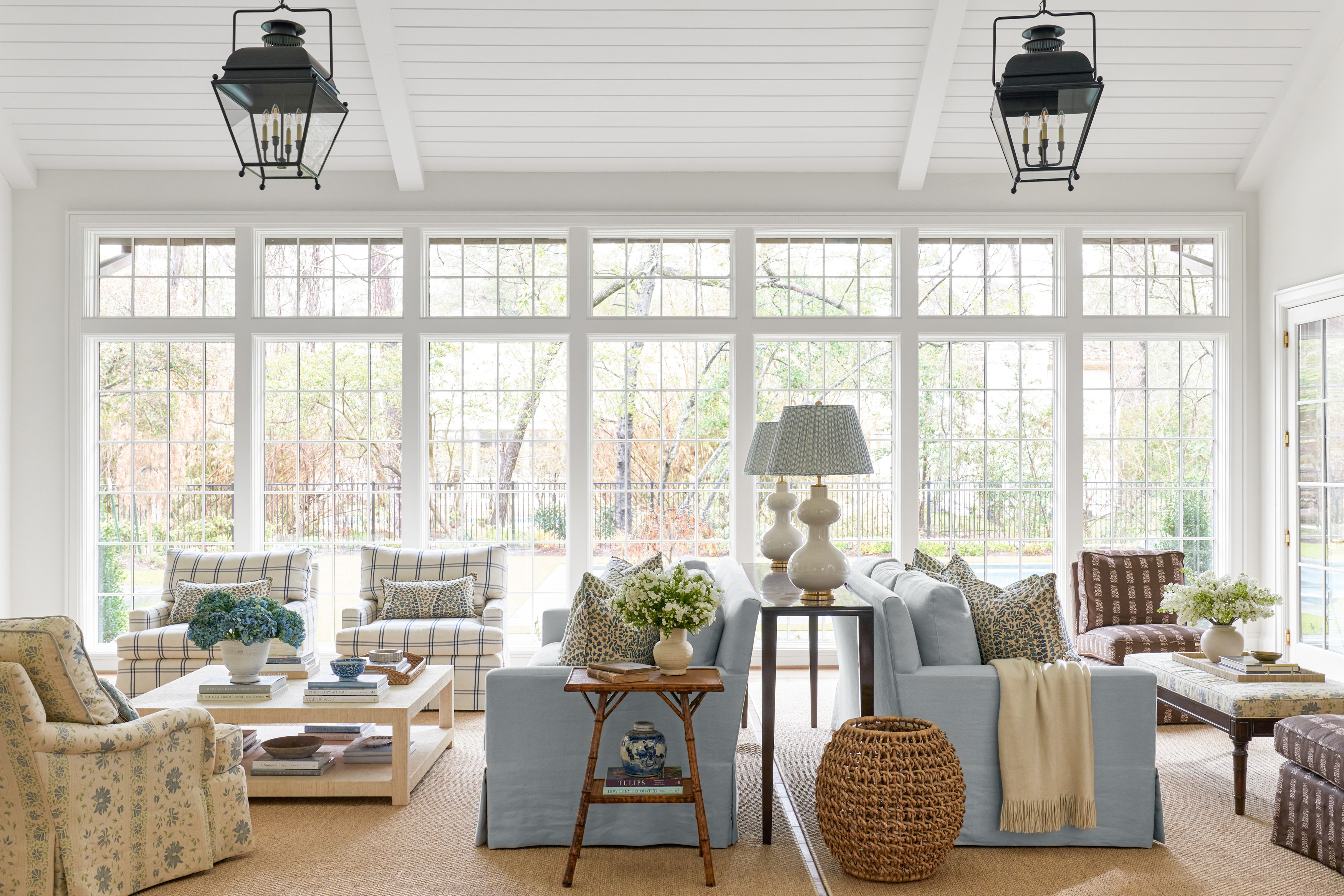 a living room filled with furniture and lots of windows