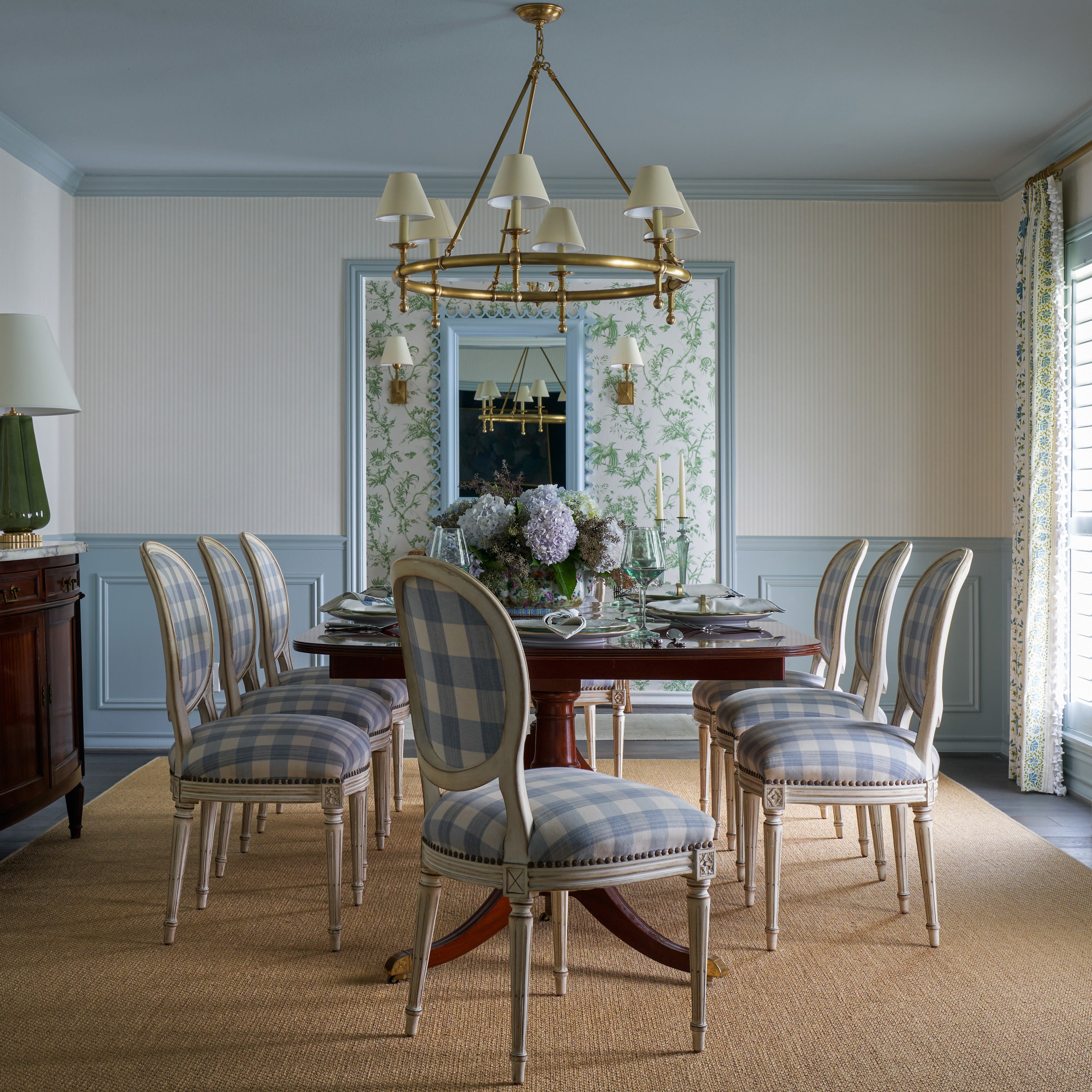 a dining room with a chandelier and chairs