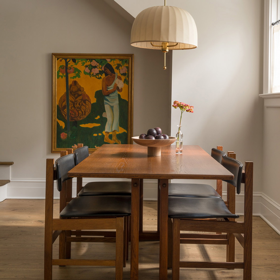 a dining room with a wooden table and chairs