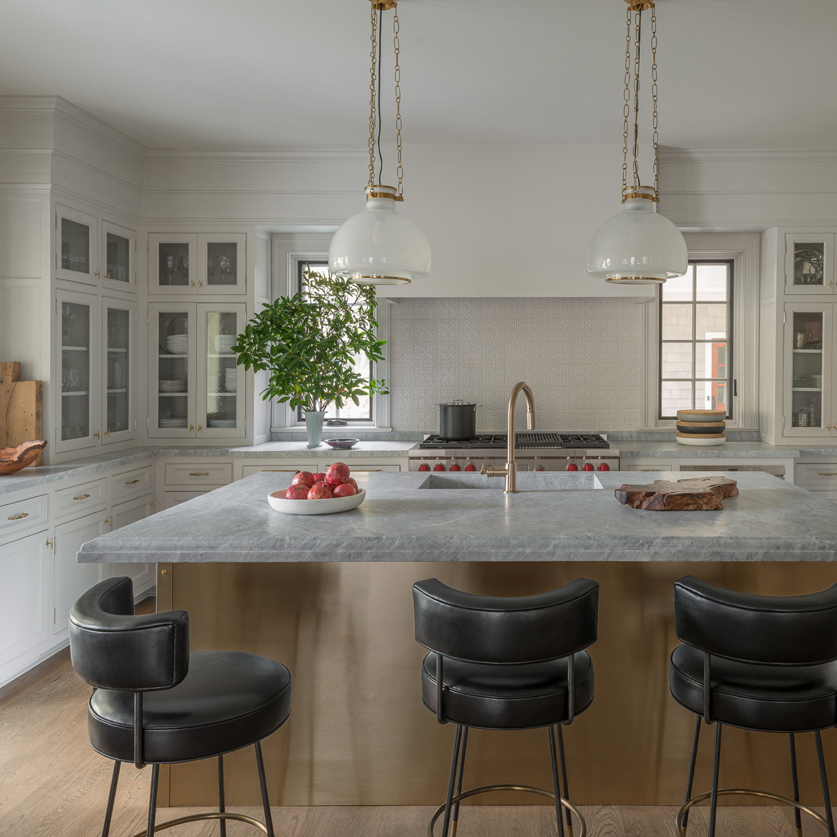 a kitchen with a center island and three bar stools