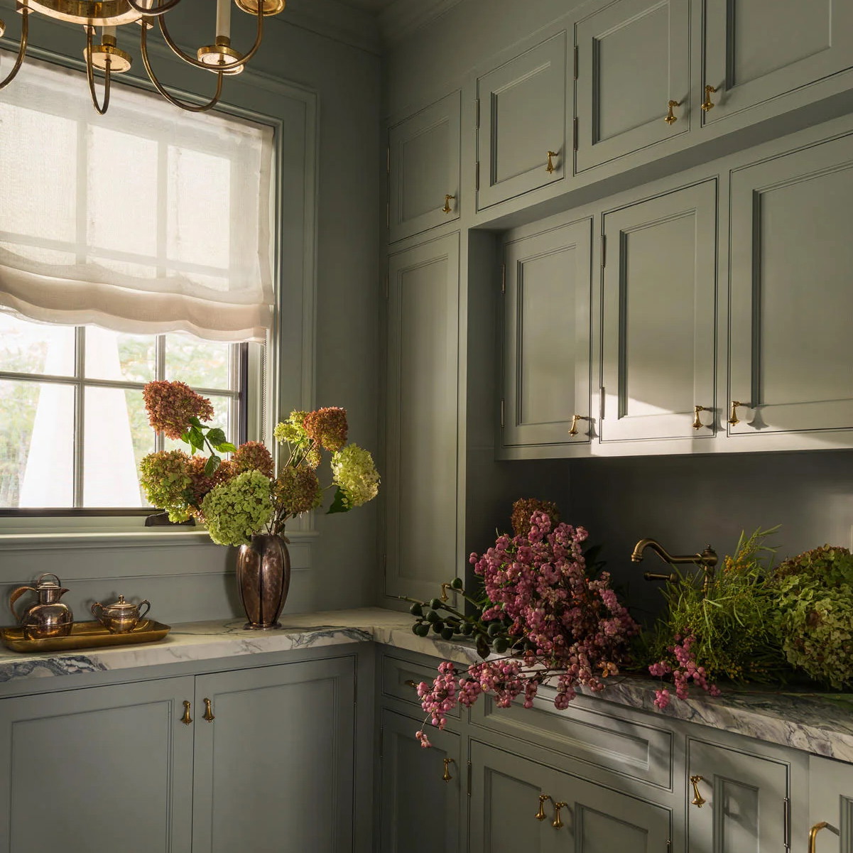 a kitchen with a checkered floor and a chandelier