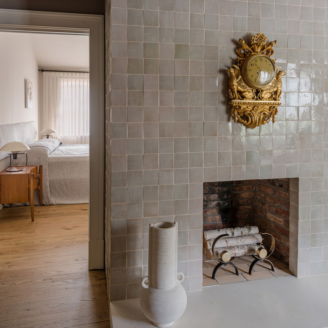 a room with a fireplace and a clock on the wall