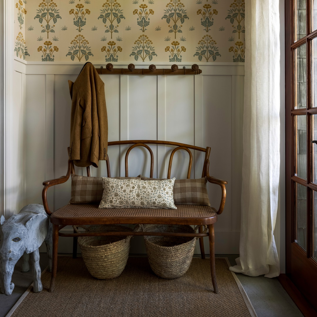 a wooden bench sitting next to a window