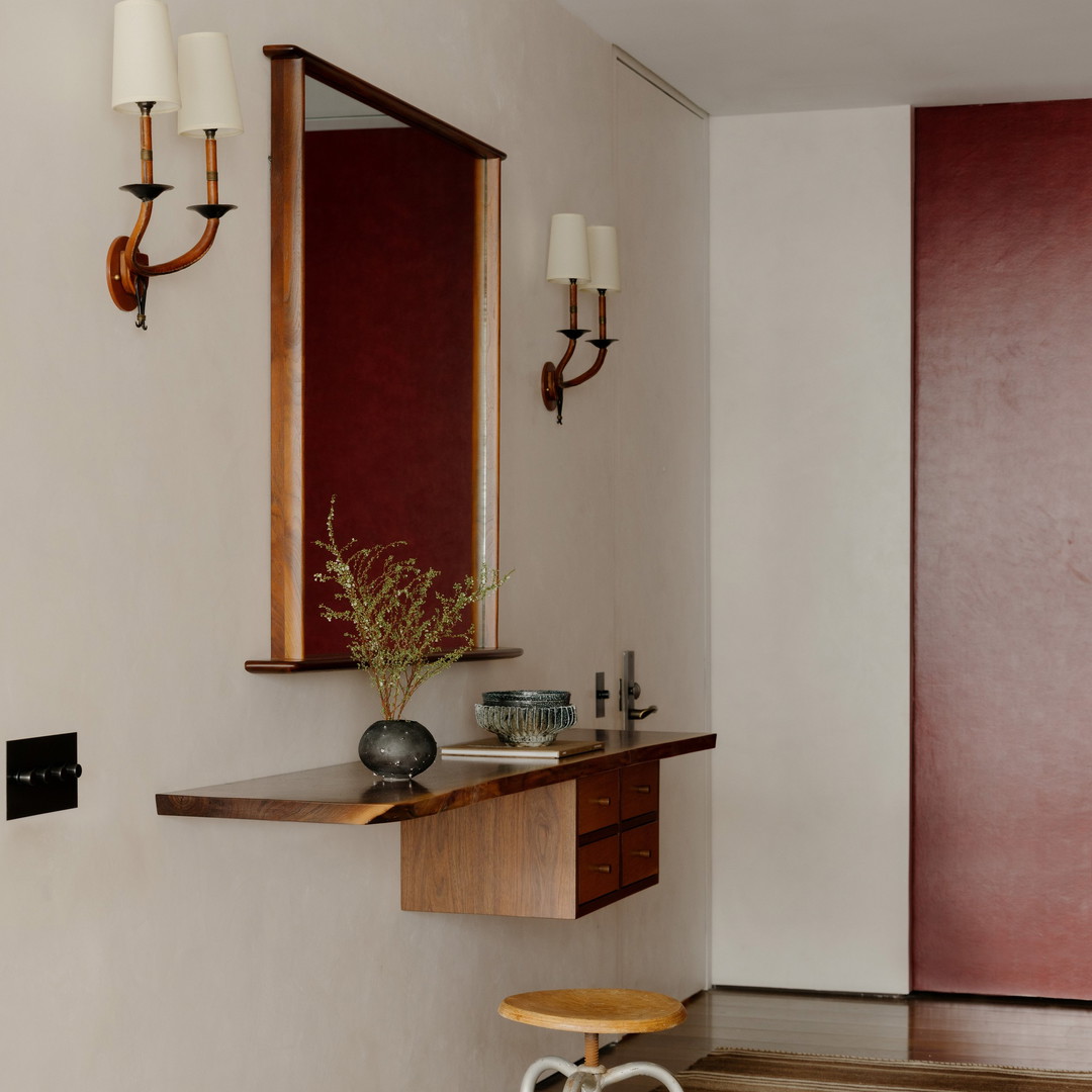 a bathroom with a stool and a mirror