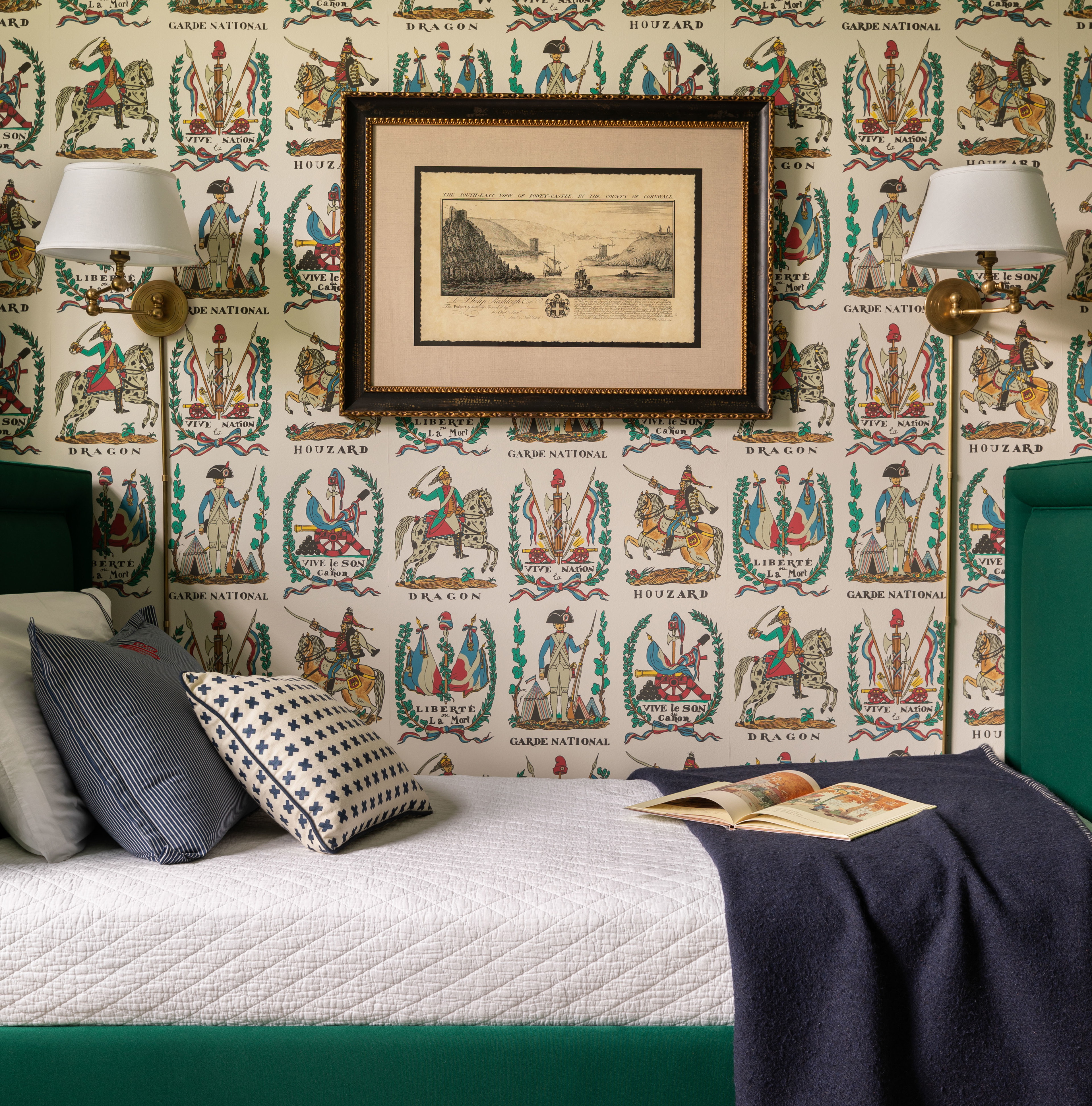 a bedroom with a green bed and a picture on the wall