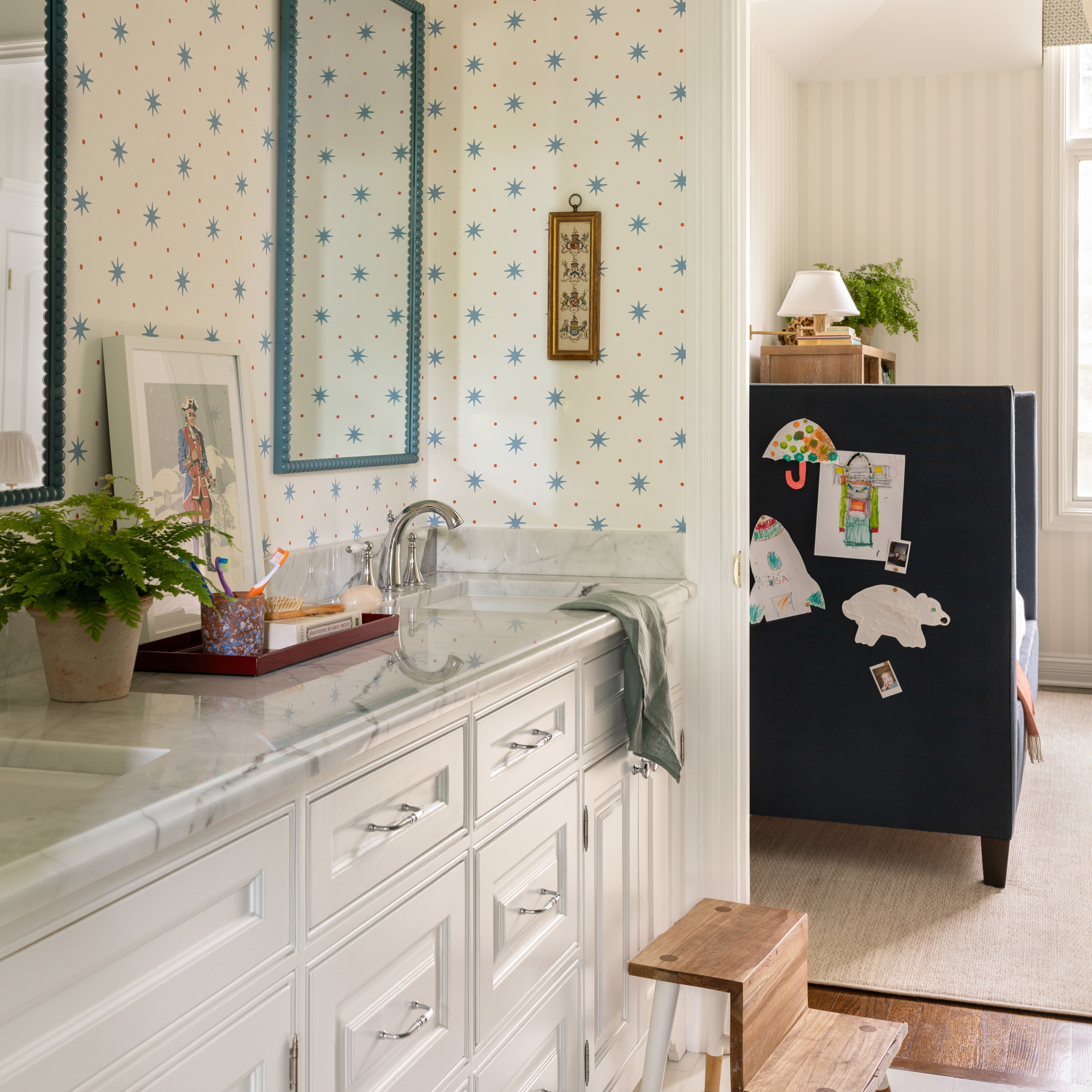 a bathroom with a sink, mirror and a refrigerator