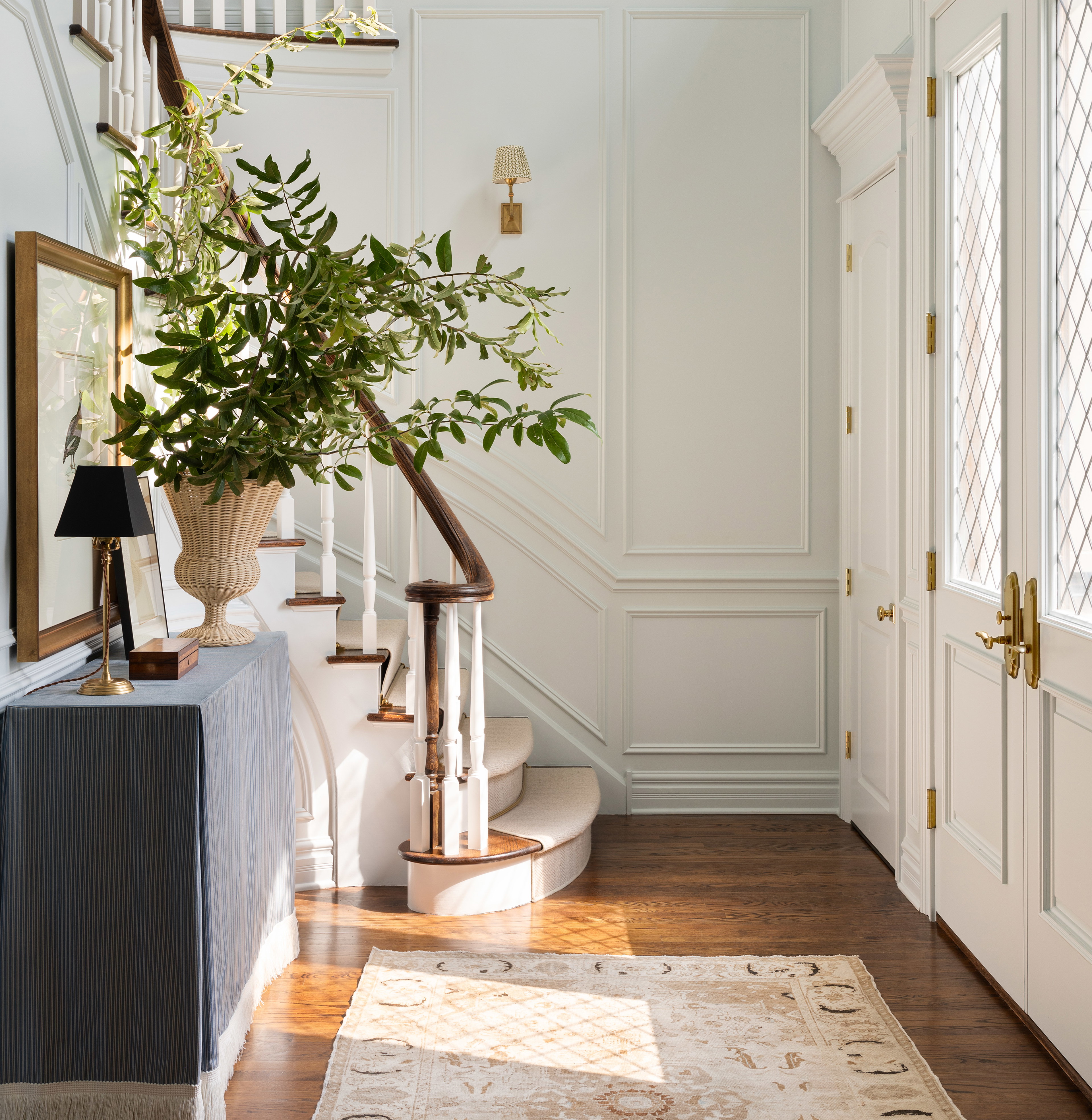 a hallway with a rug and a painting on the wall