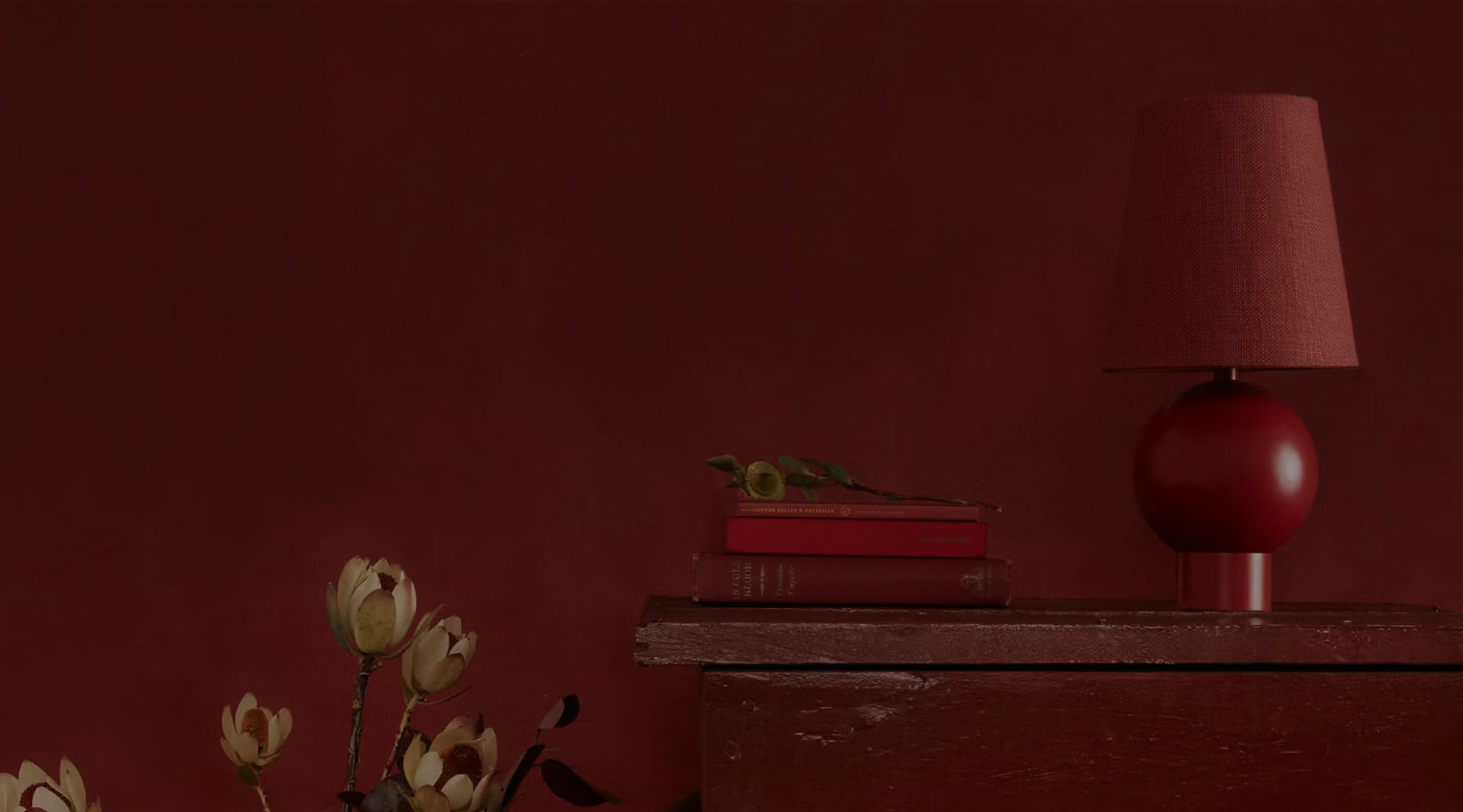 a table with a lamp and a vase with flowers on it