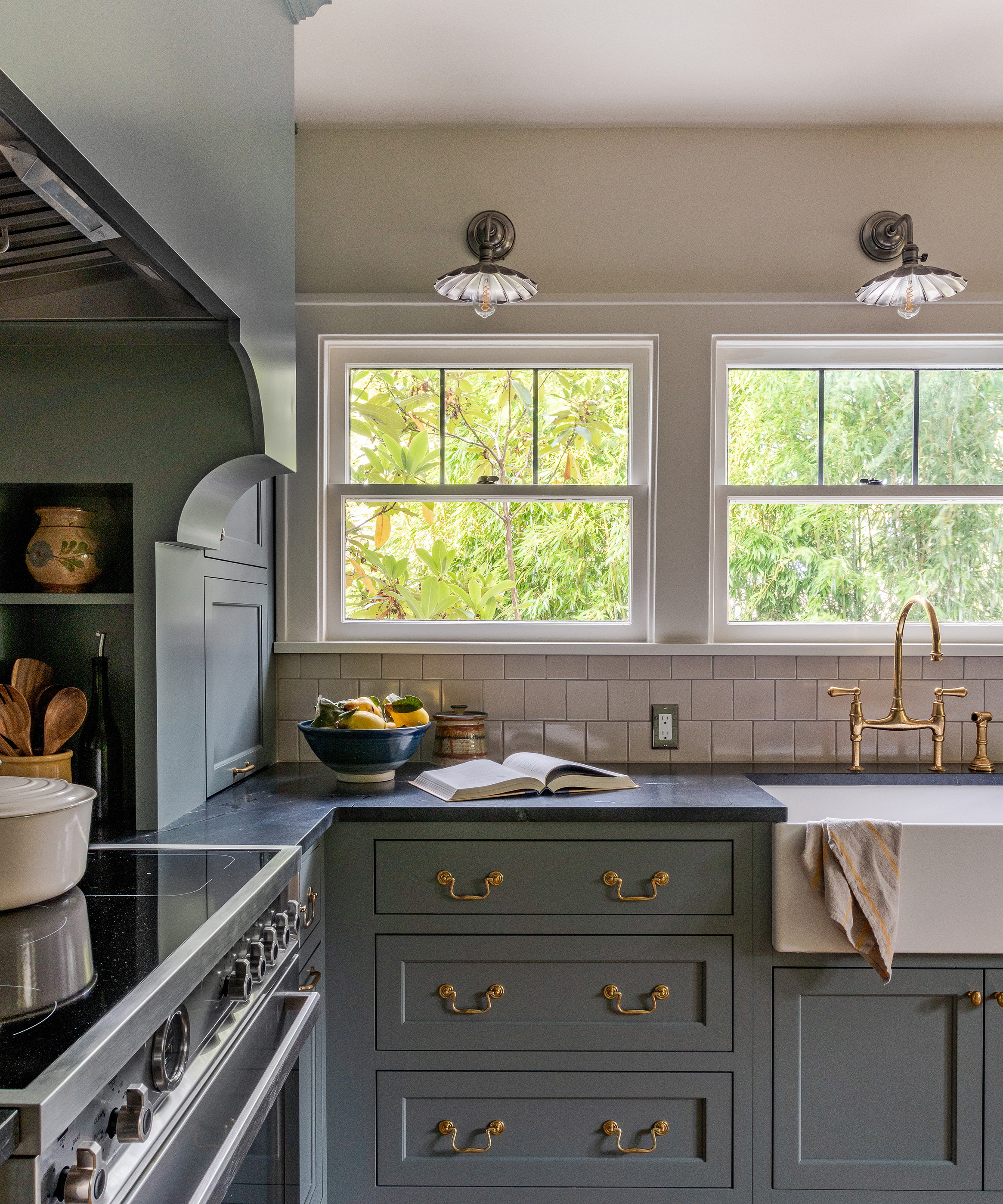 a kitchen with a sink, stove, and oven