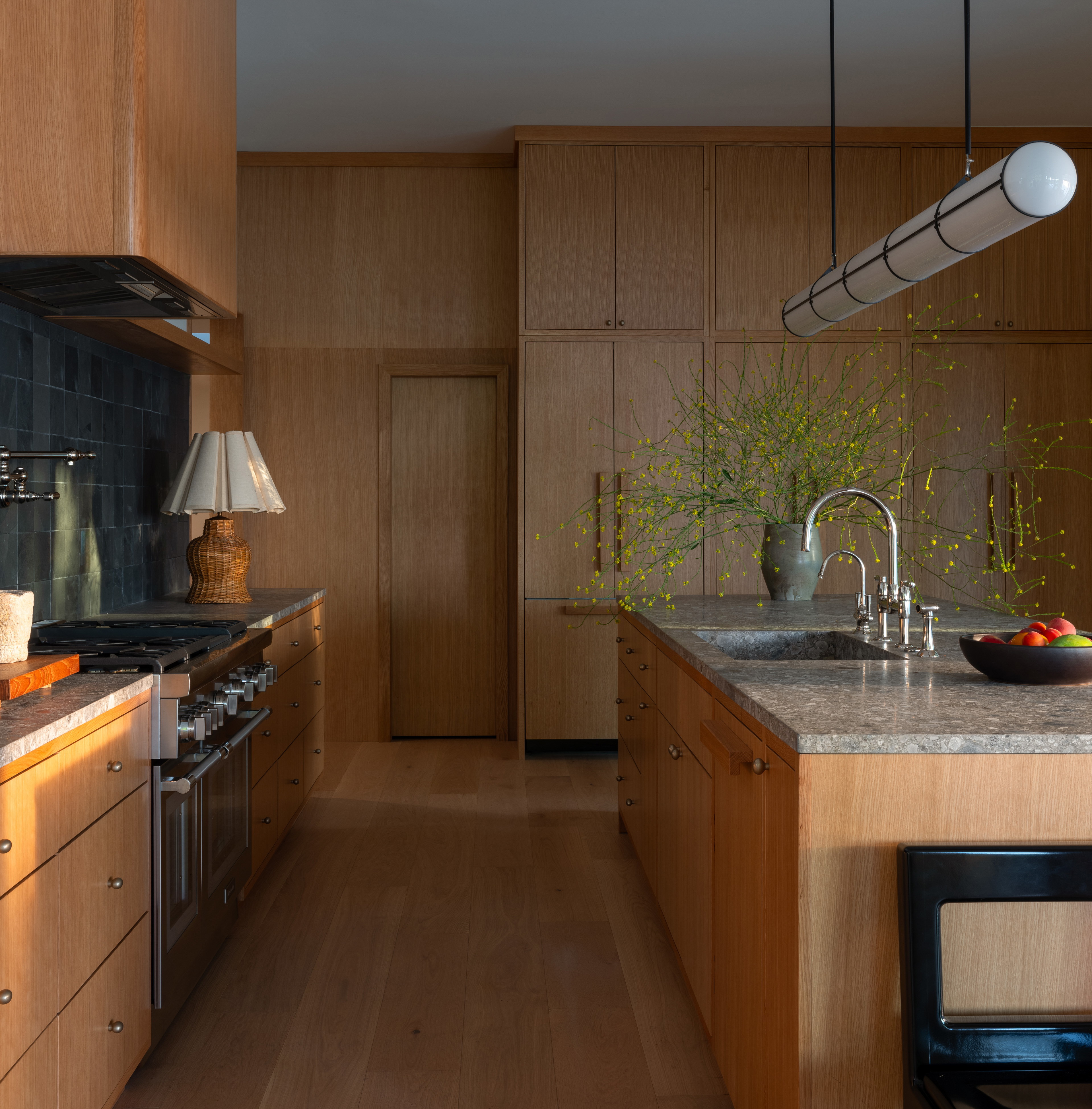 a kitchen with a sink, stove, oven, and dishwasher