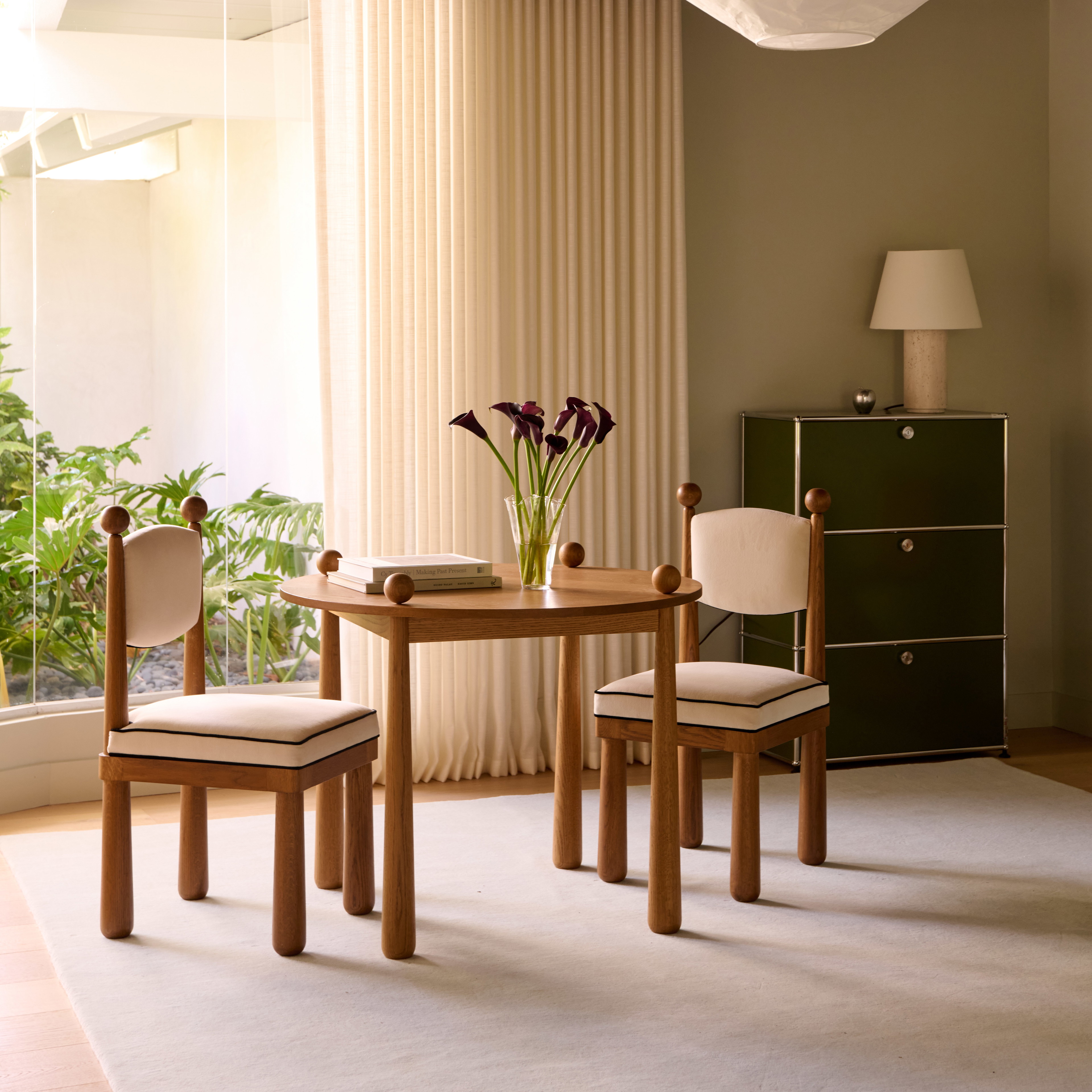 a living room with a table and two chairs