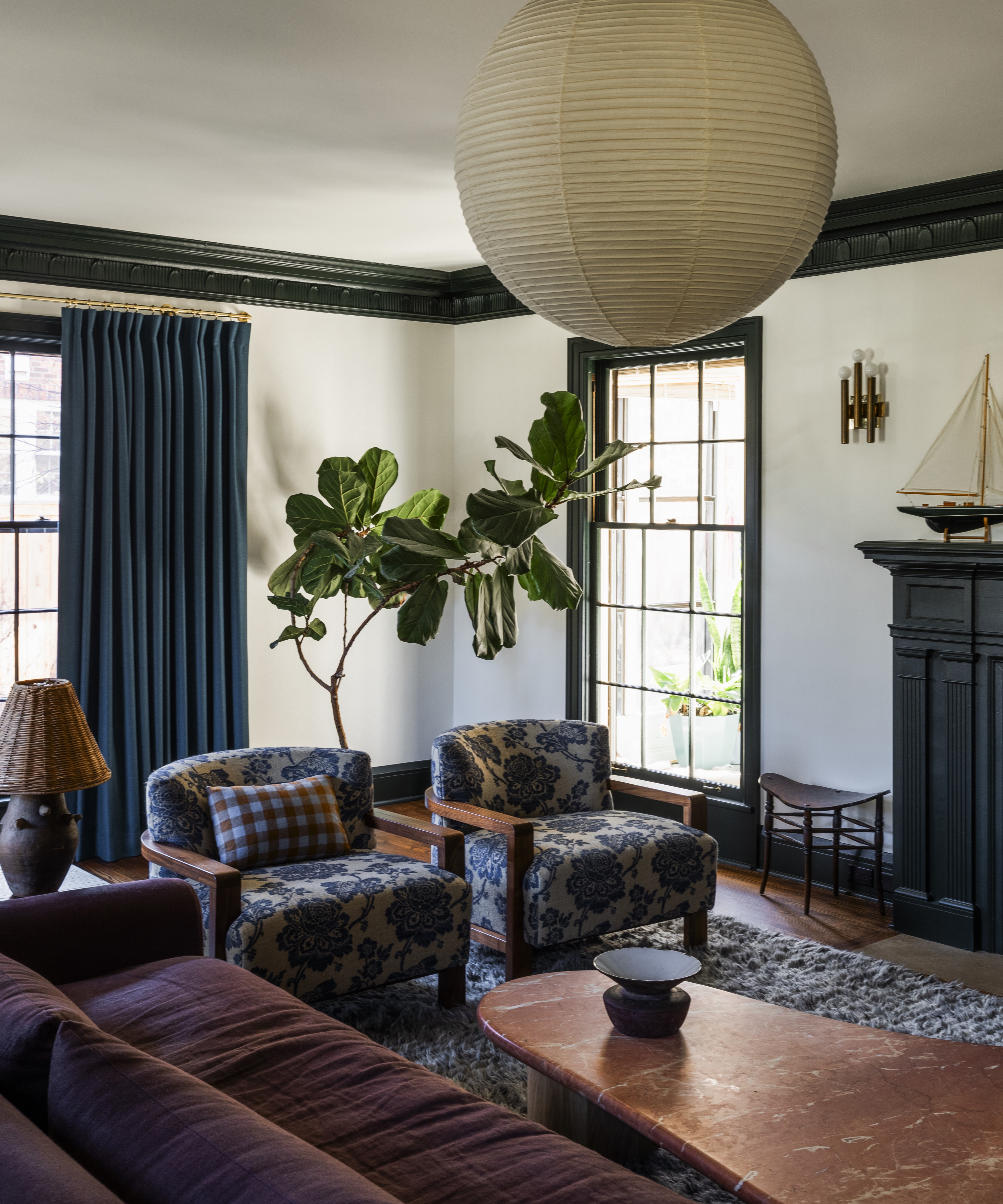 a living room filled with furniture and a potted plant