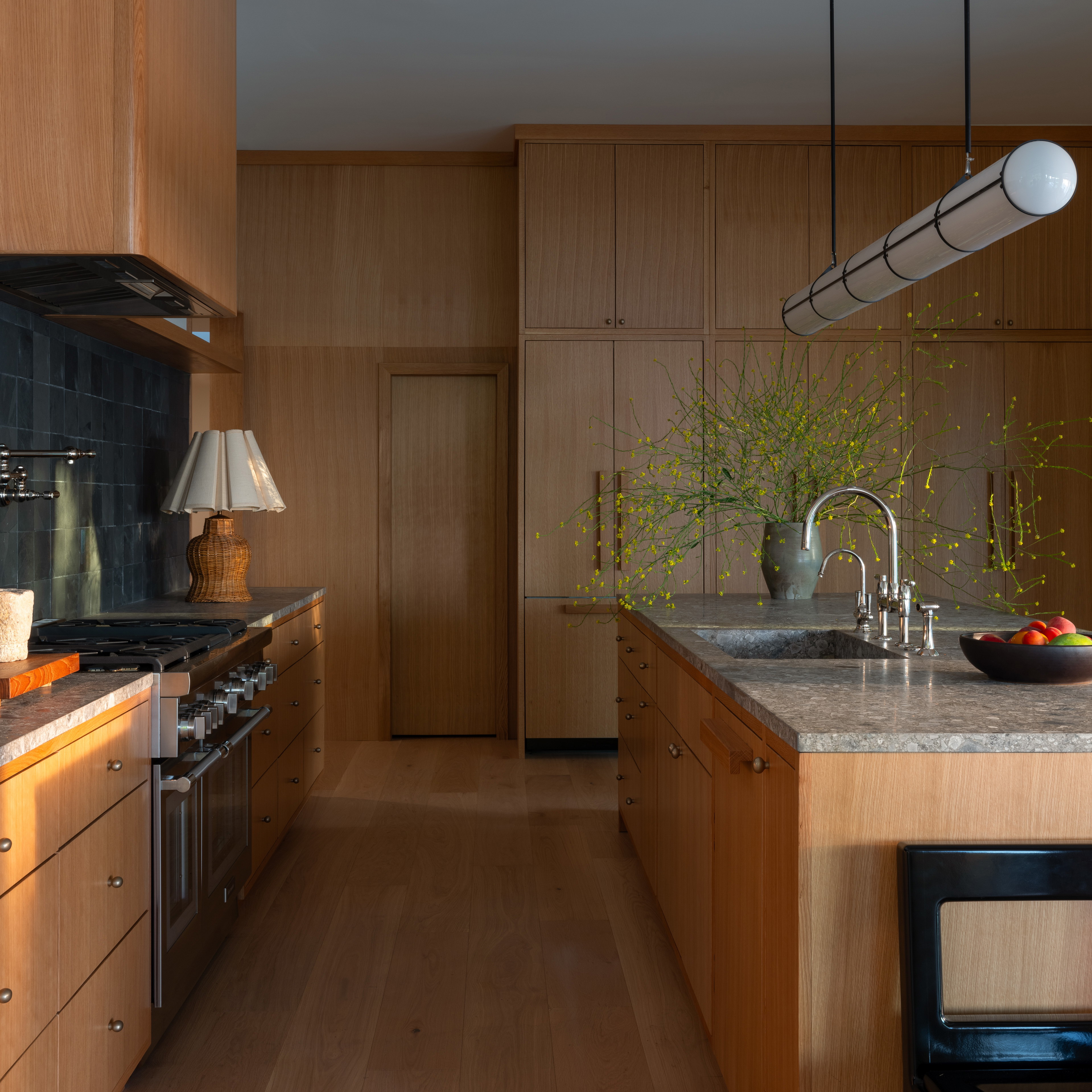 a kitchen with a sink, stove, oven, and dishwasher