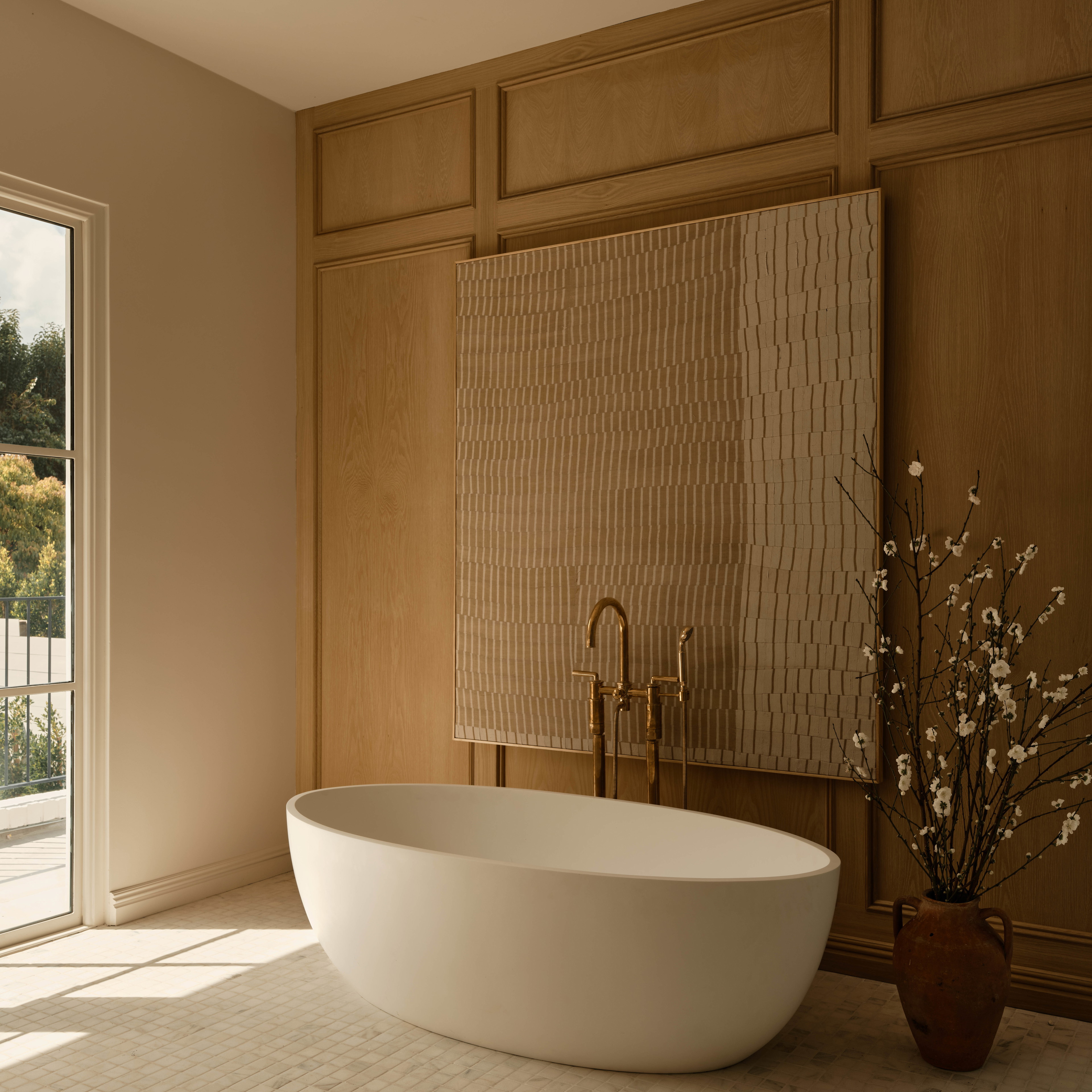 a large white bath tub sitting next to a window