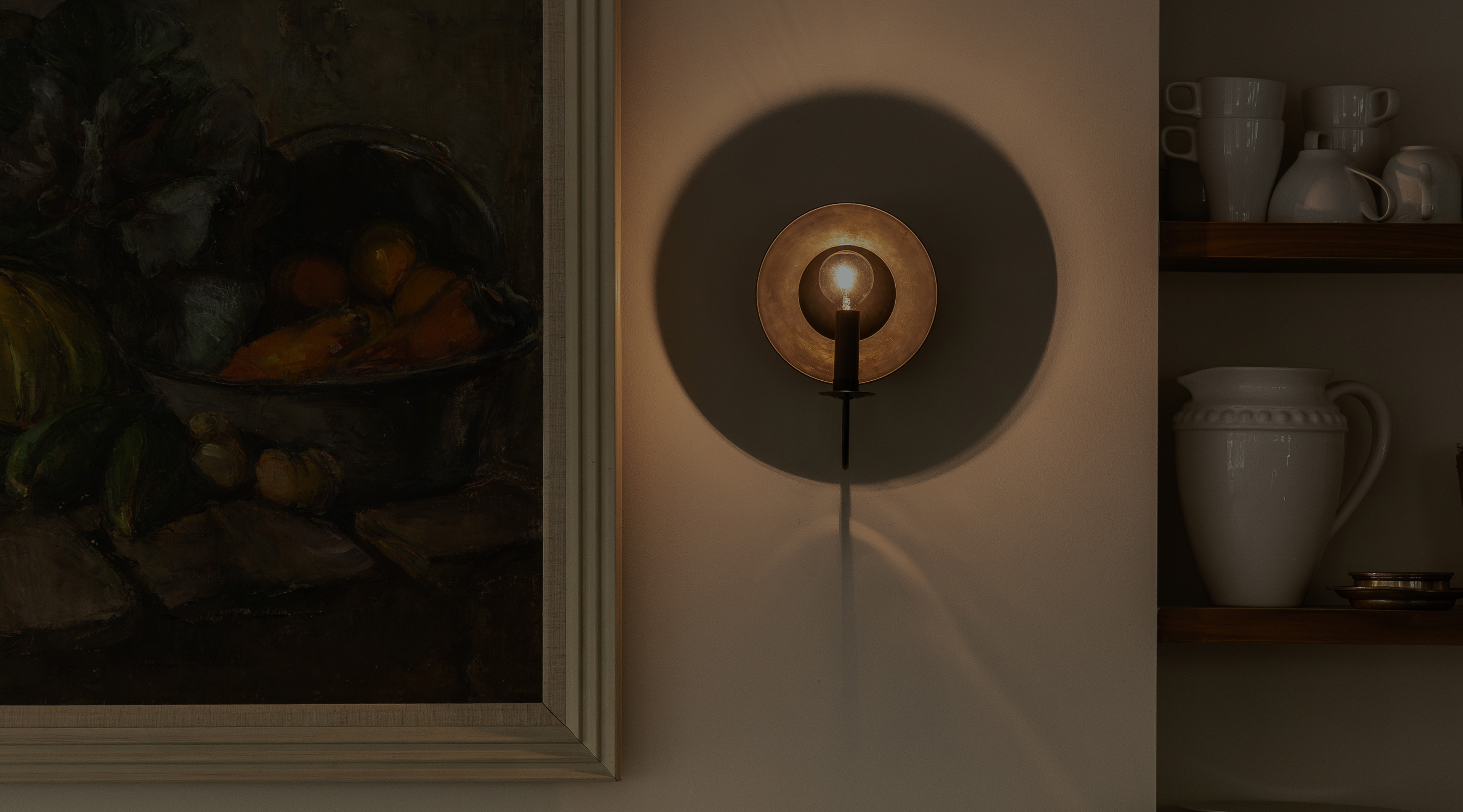 a painting on a wall next to a wall light