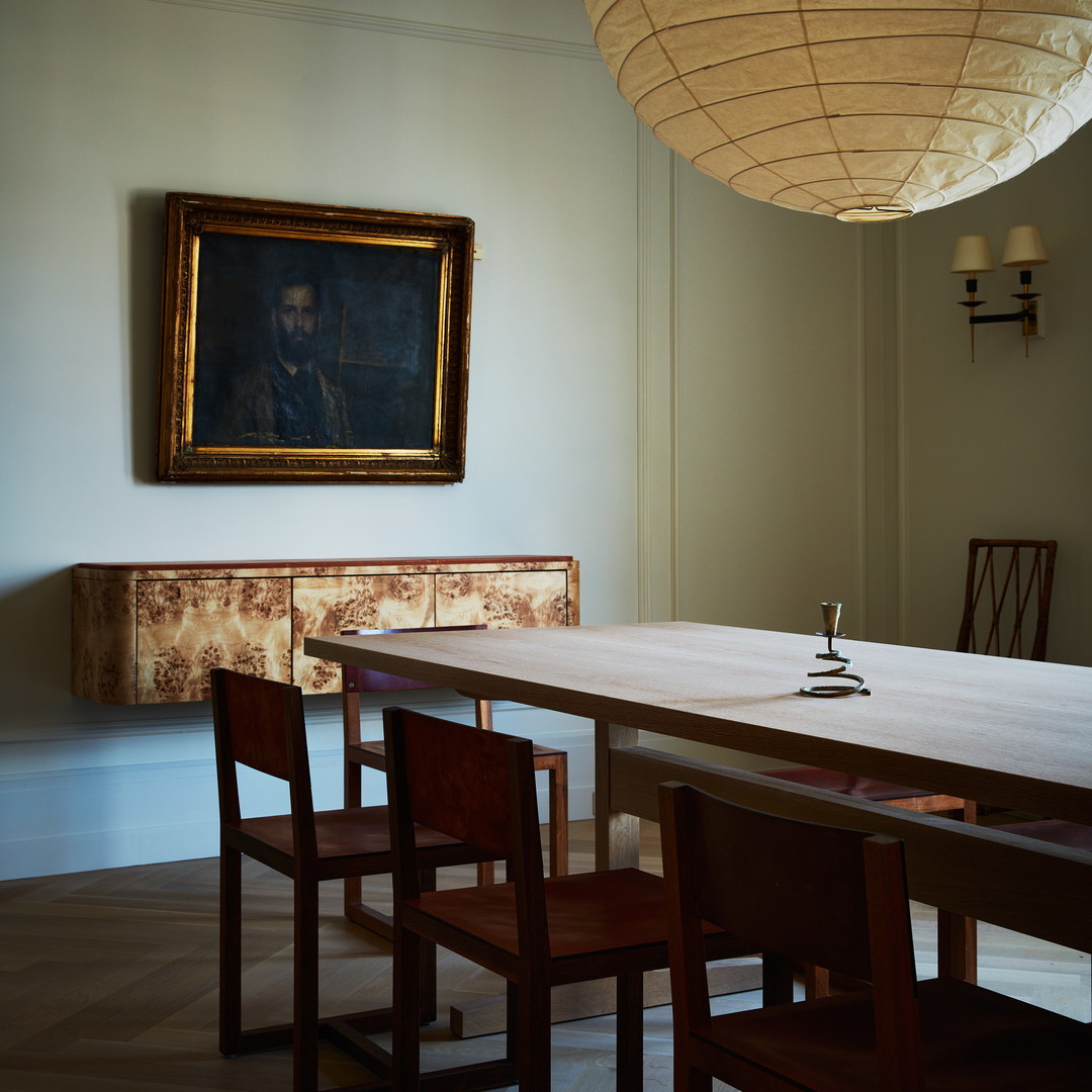 a dining room with a table and four chairs