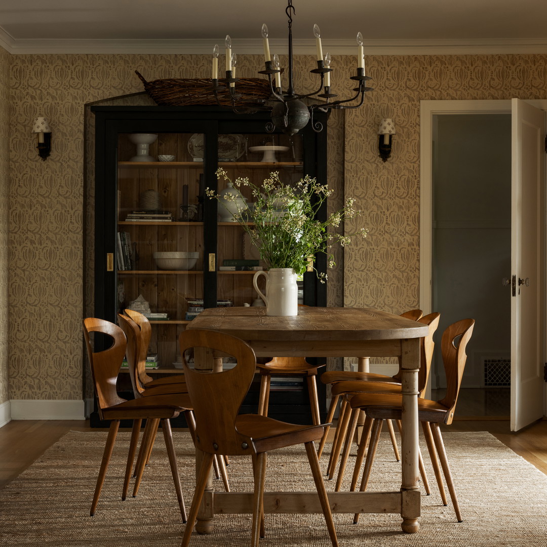 a dining room with a table and chairs