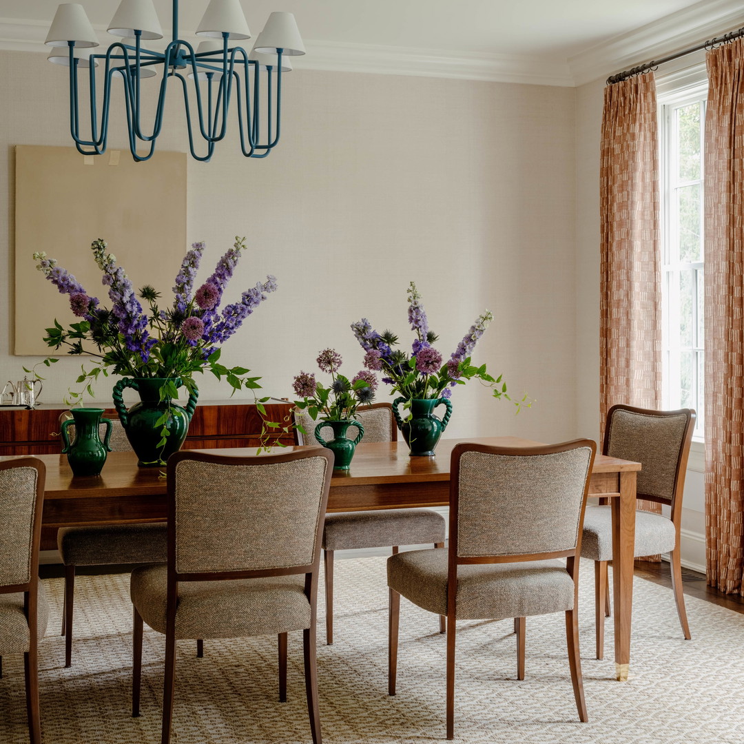 a dining room with a table and chairs and a chandelier