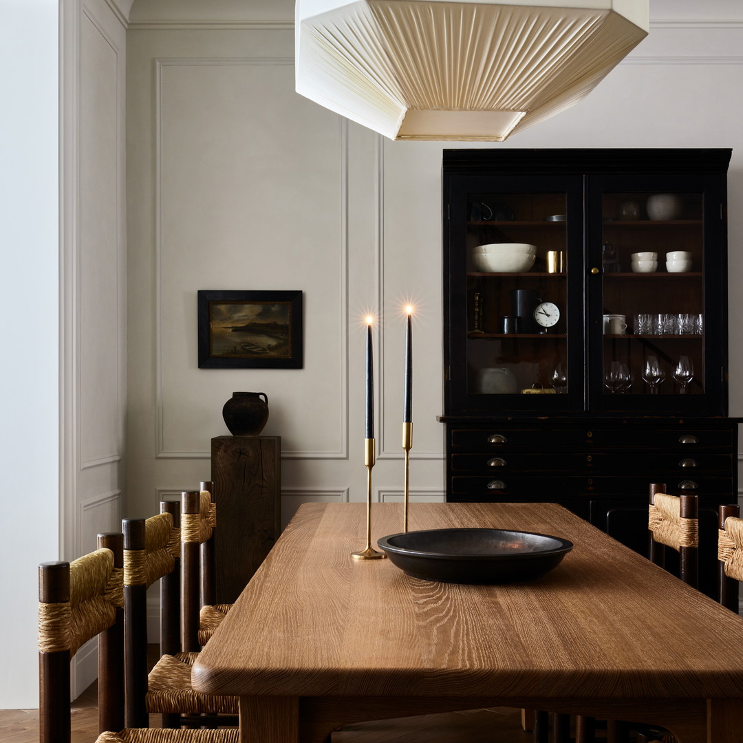 a dining room with a wooden table and chairs