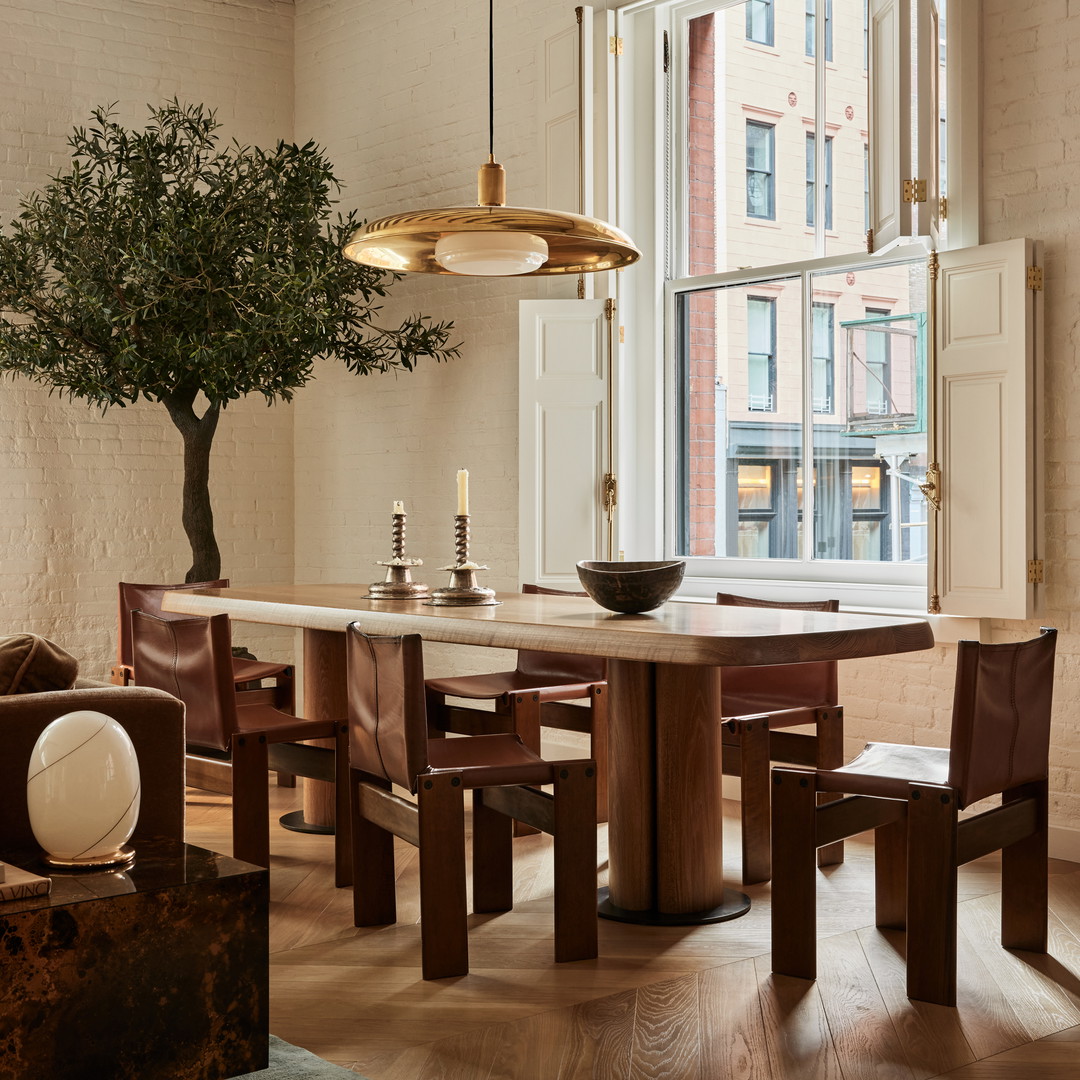 a dining room with a table and chairs