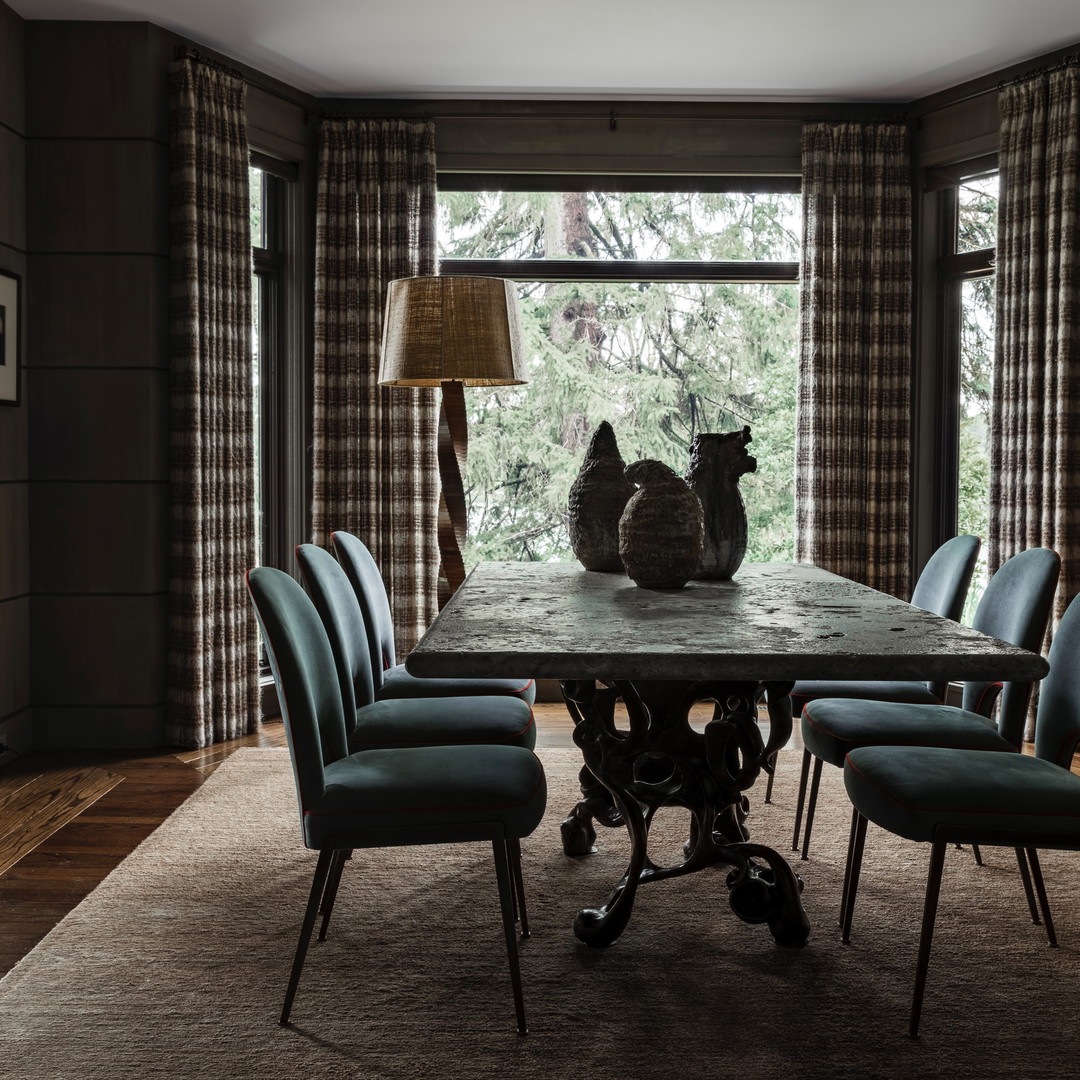 a dining room table with chairs and a cat statue