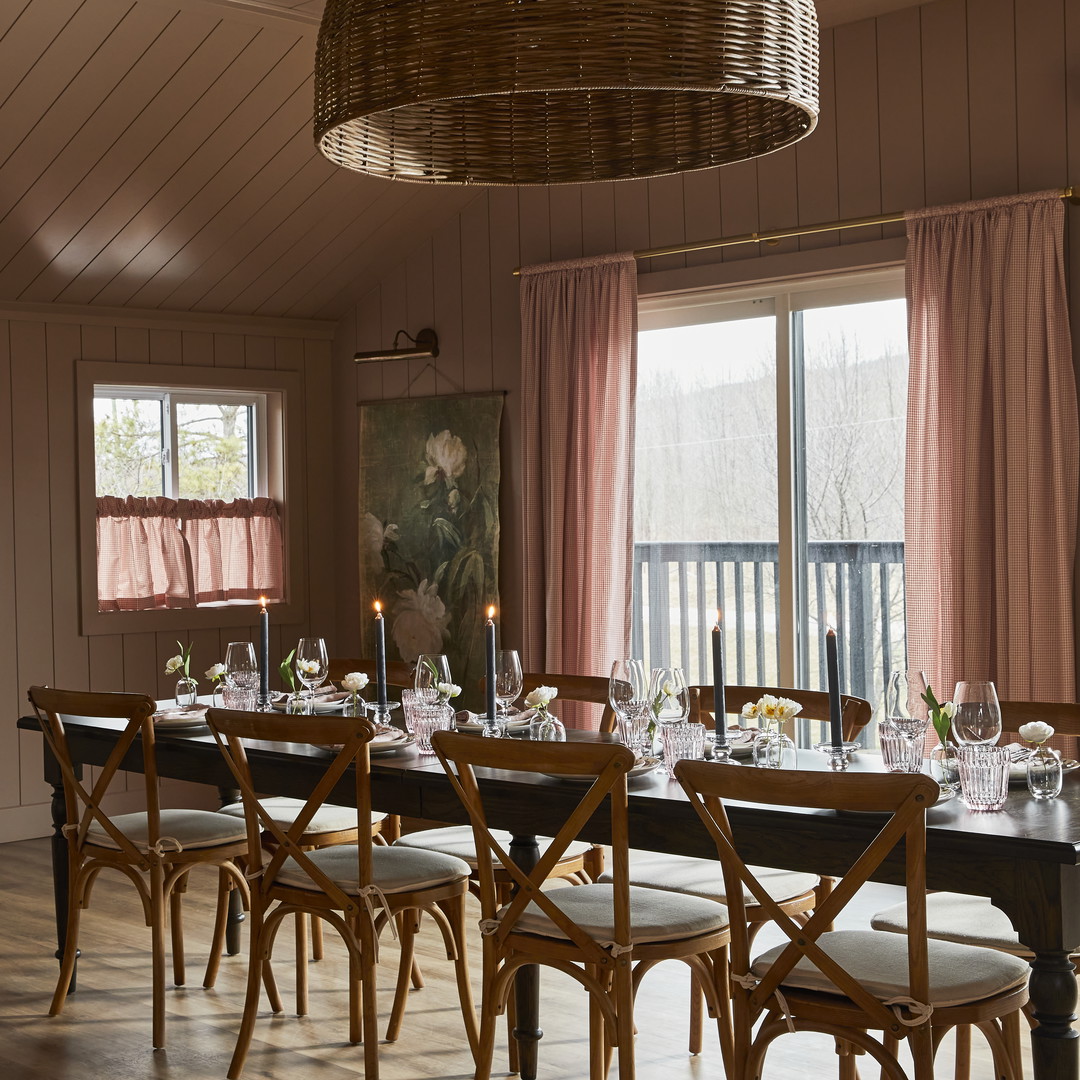 a dining room table with chairs and a chandelier