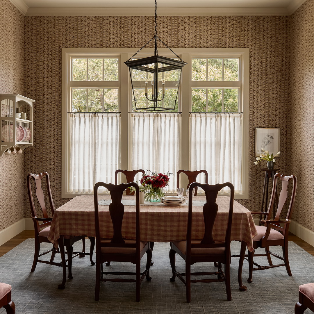 a dining room with a table and chairs