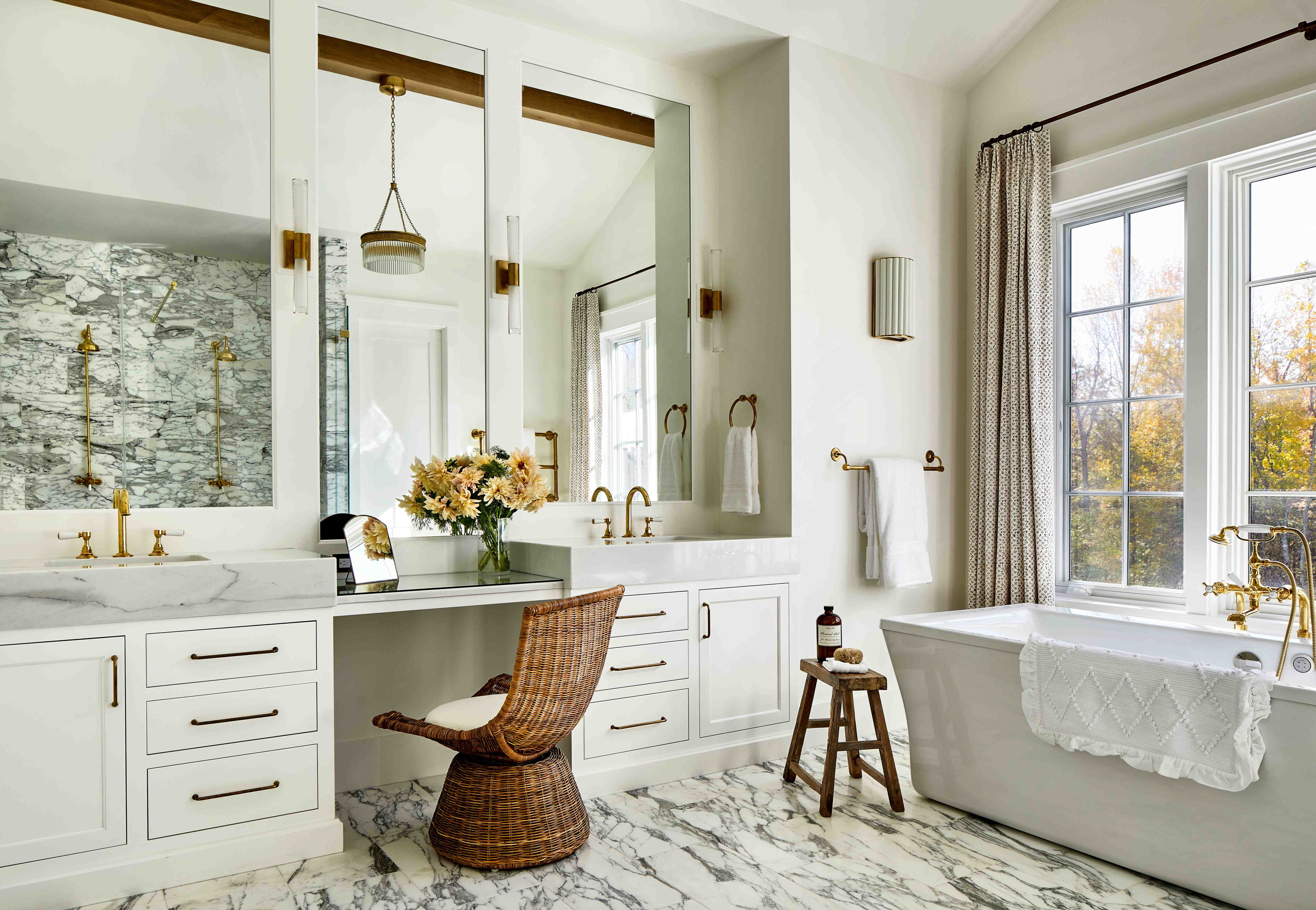 a bathroom with a tub, sink, and mirror