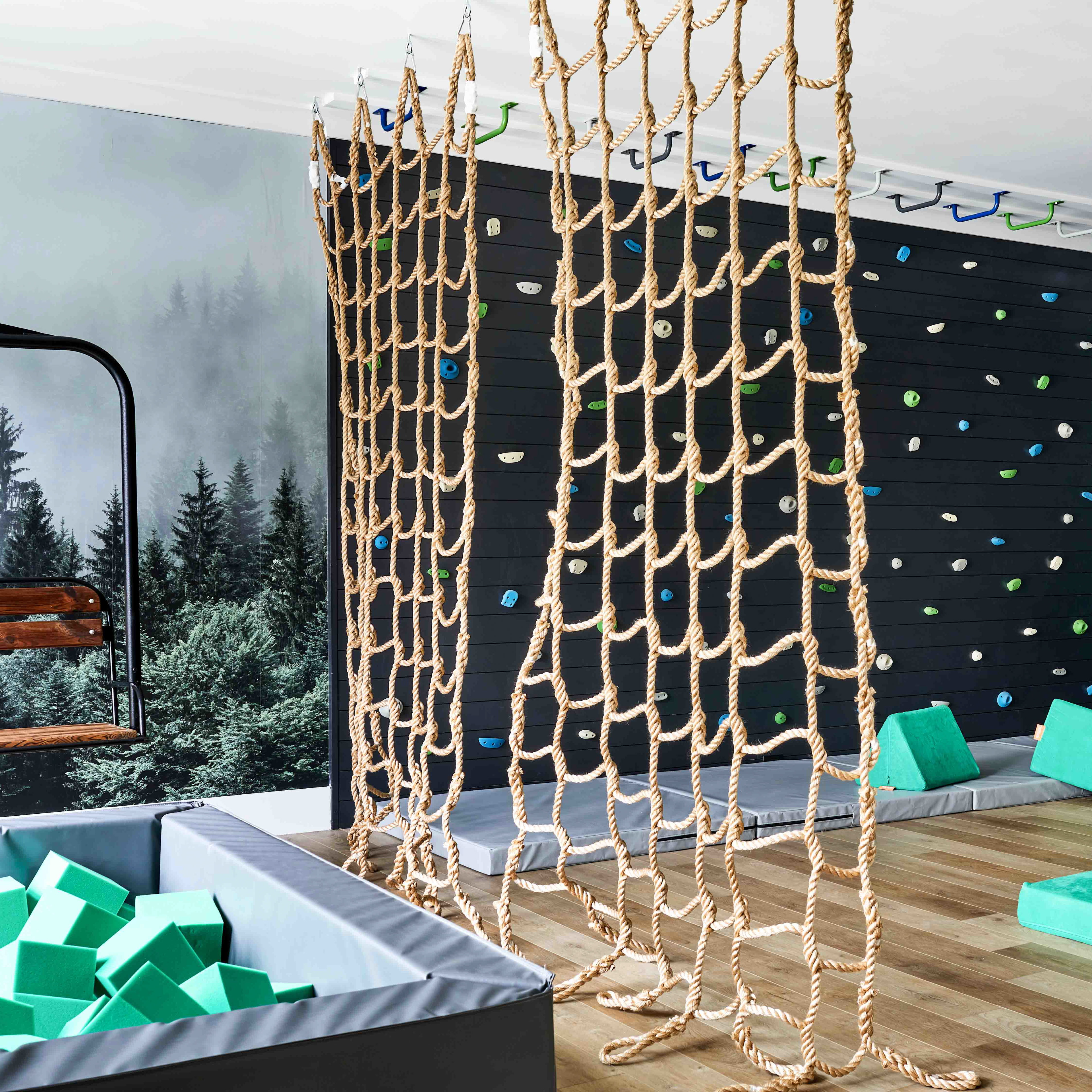 a room with a climbing wall and a play area