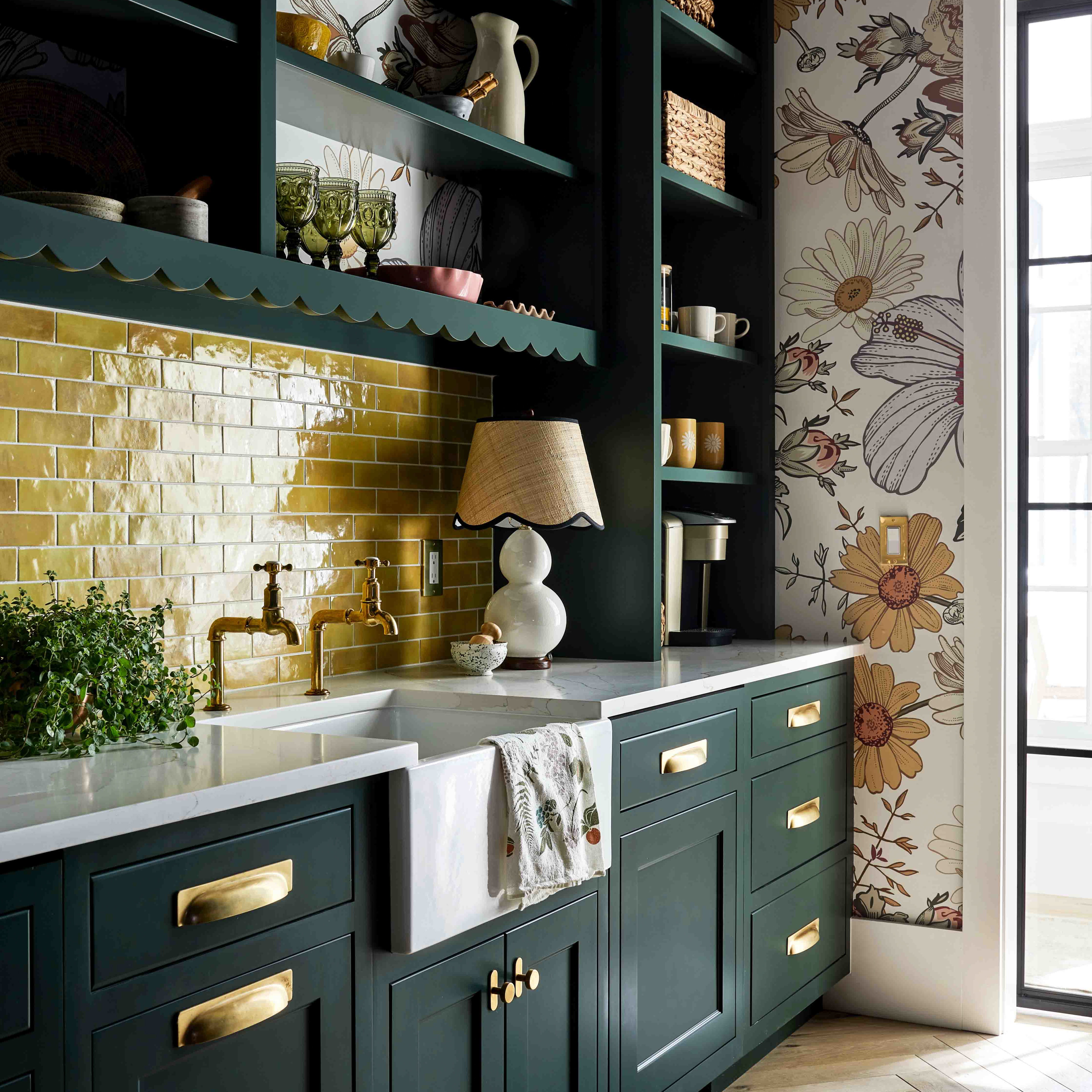 a kitchen with green cabinets and a white sink