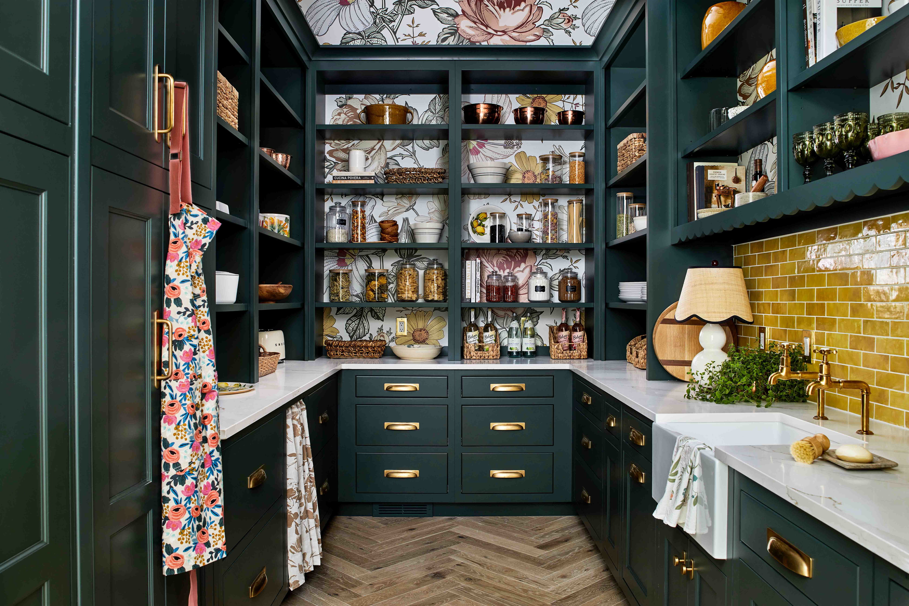 a kitchen with green cabinets and a white sink