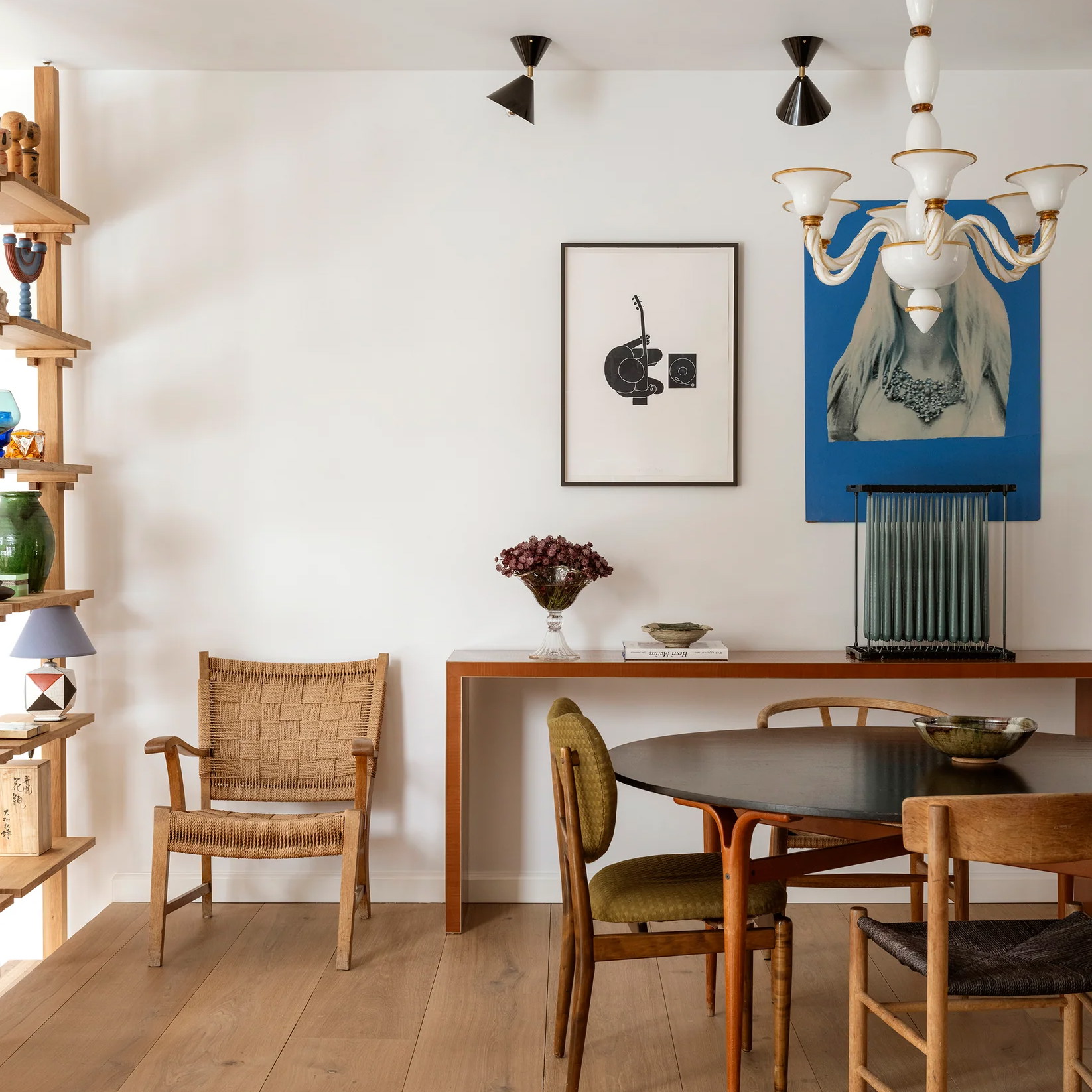 a dining room with a wooden table and chairs