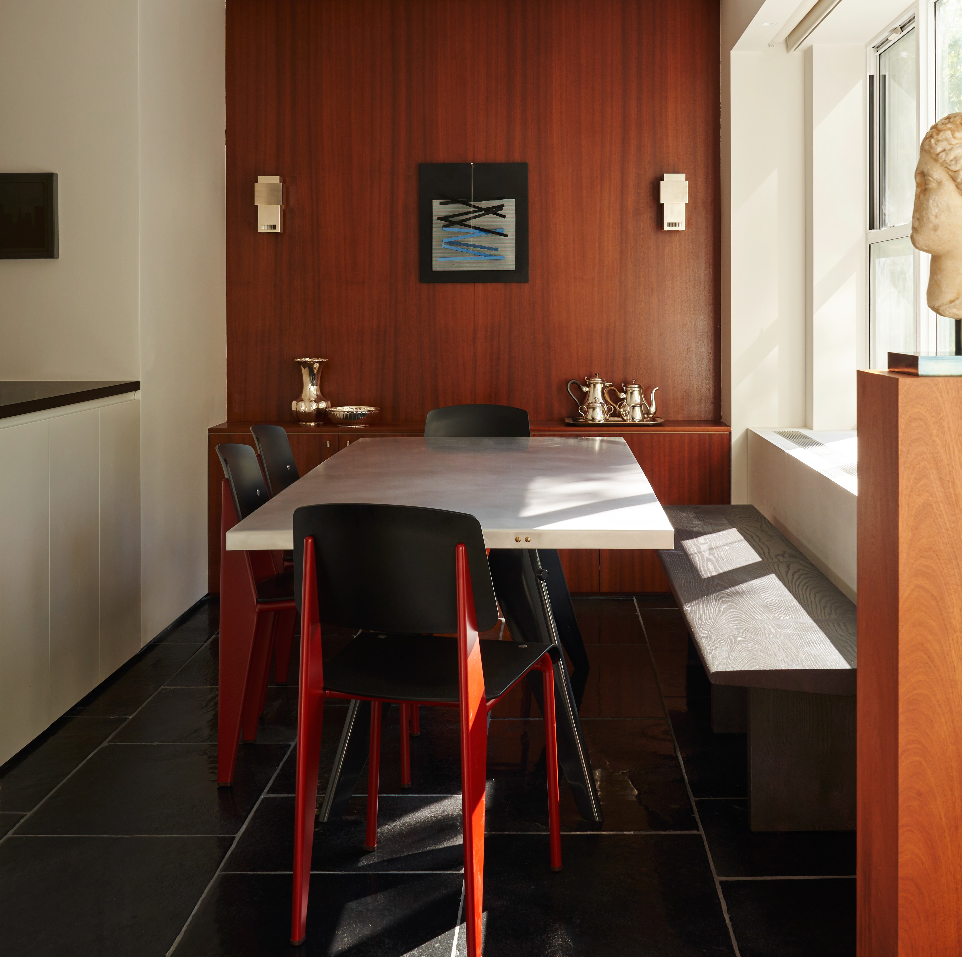 a dining room with a long table and chairs