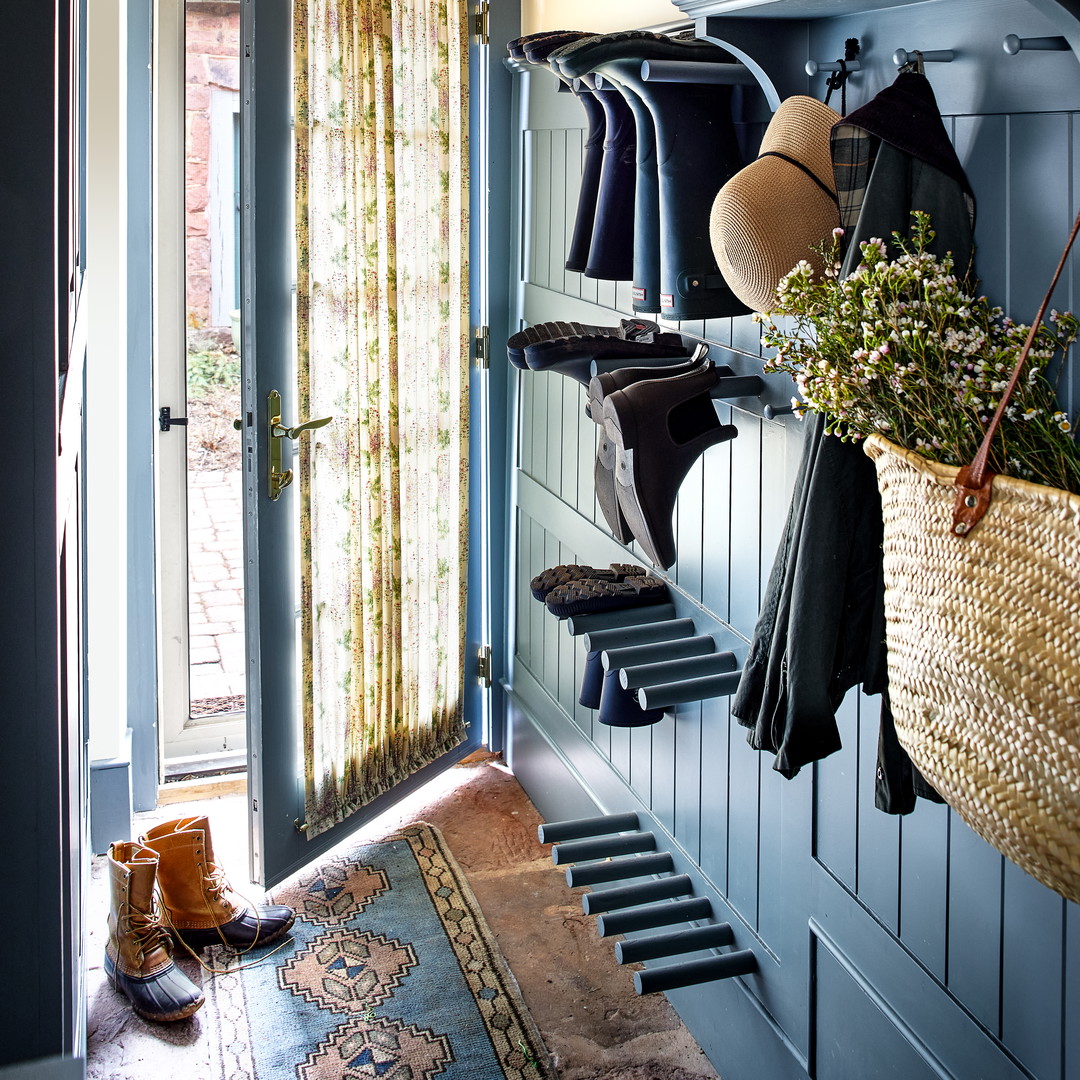 a room with a bunch of clothes hanging on a rack