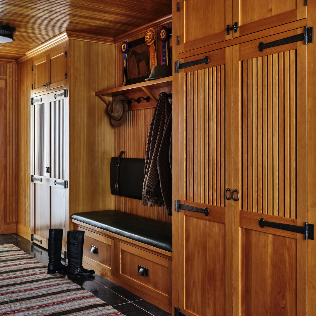 a room with wooden cabinets and a striped rug