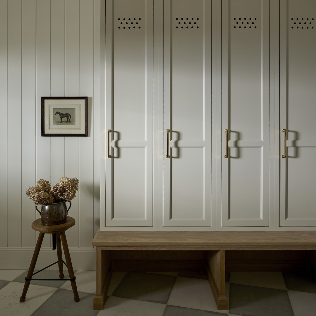 a room with a checkered floor and white cabinets