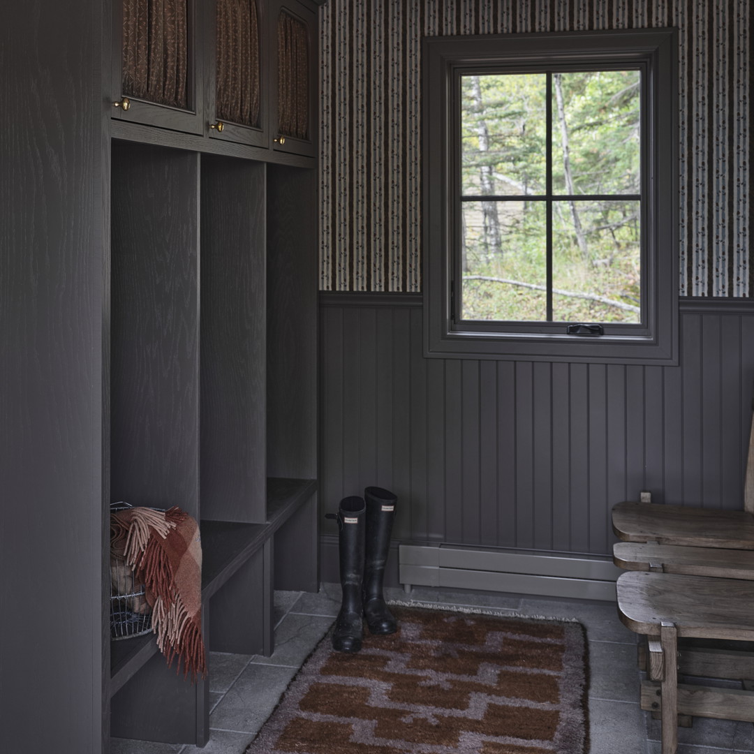 a room with a bench and a rug on the floor