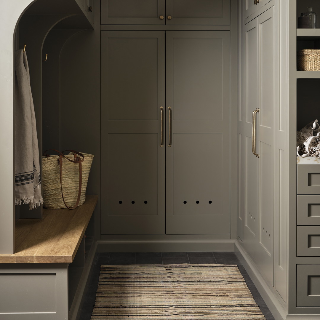 a kitchen with gray cabinets and a wooden counter