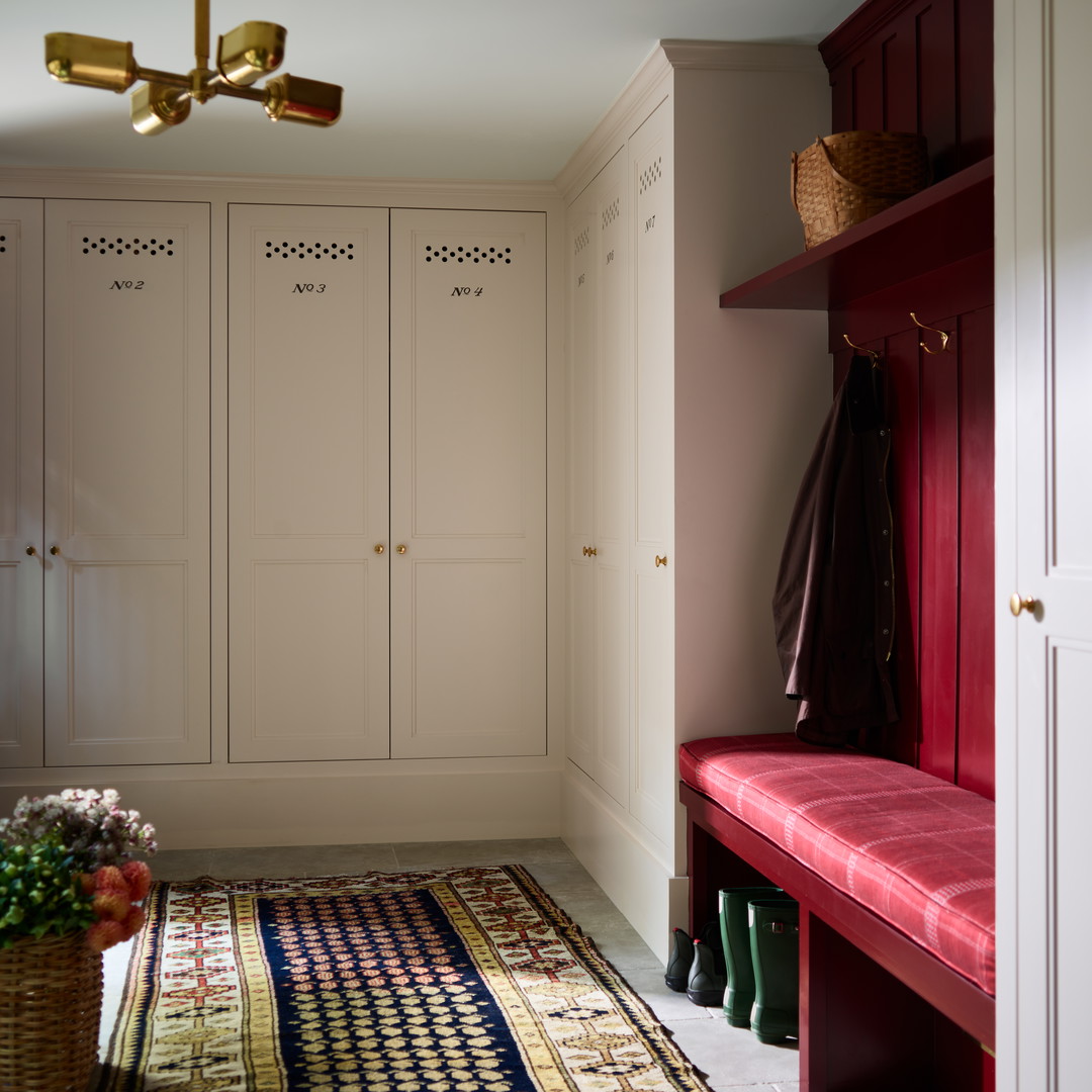 a hallway with a bench and a rug on the floor