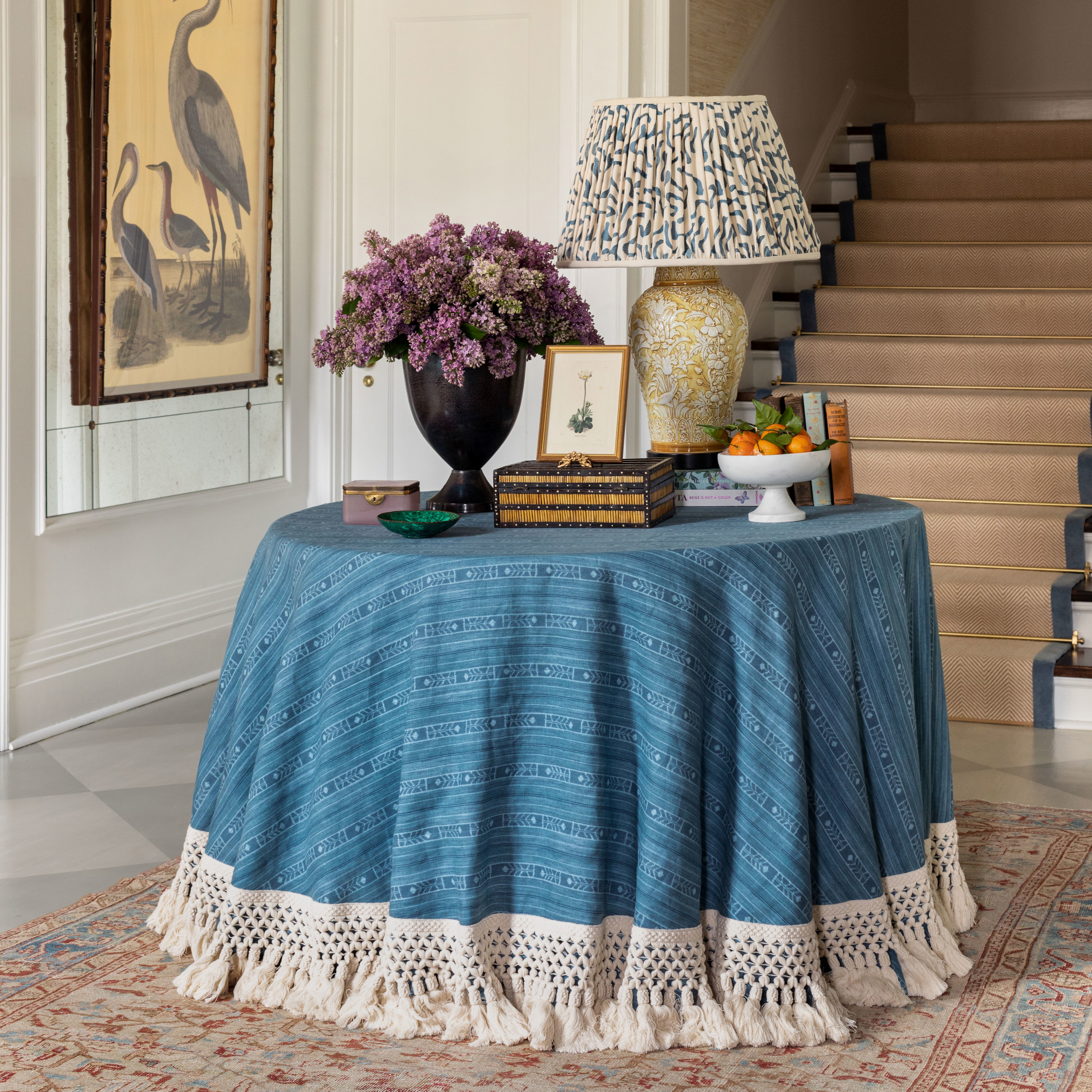 a table with a blue table cloth and a lamp