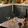 a wooden table topped with wine glasses and a bottle of wine