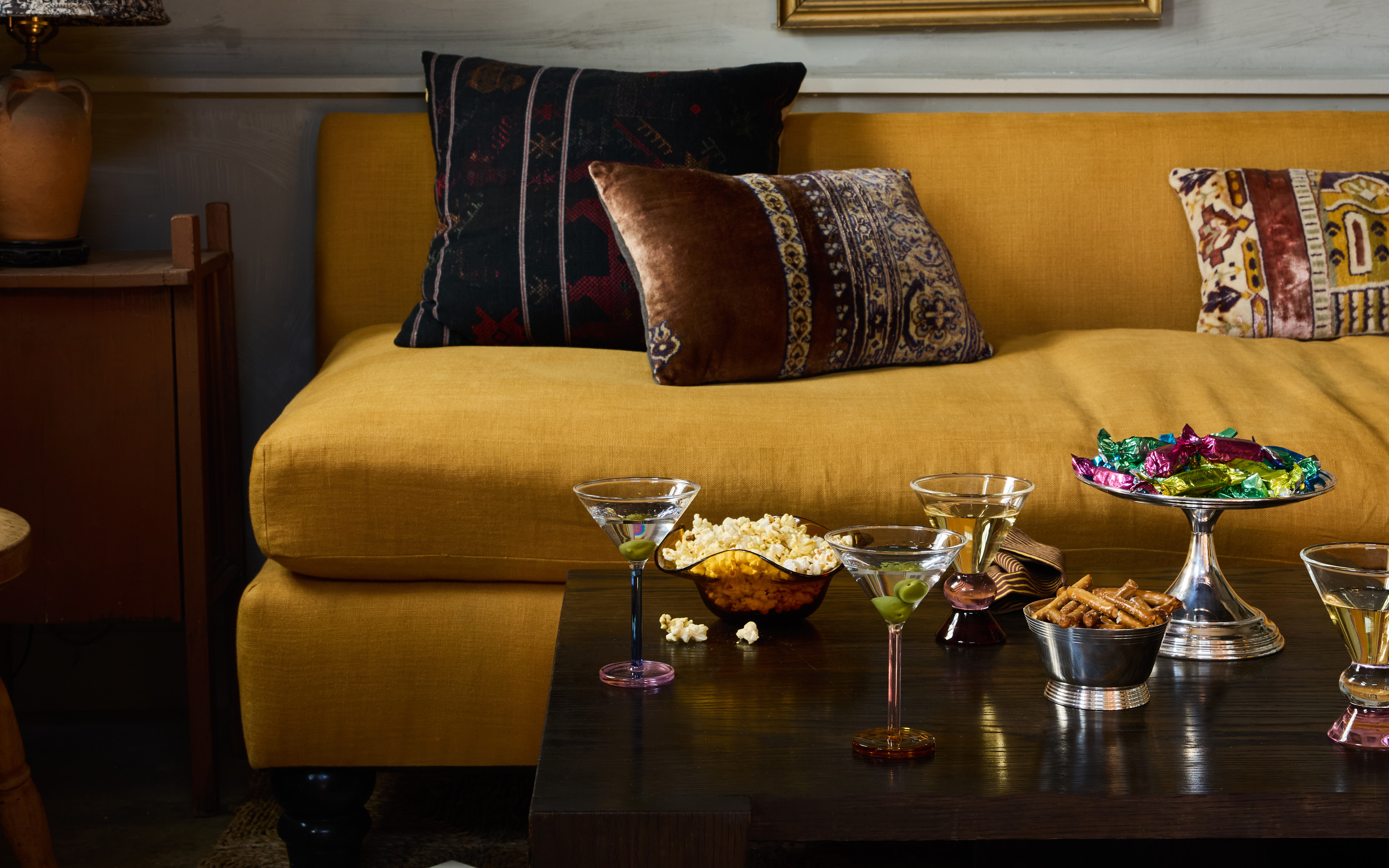 a living room filled with furniture and a painting on the wall