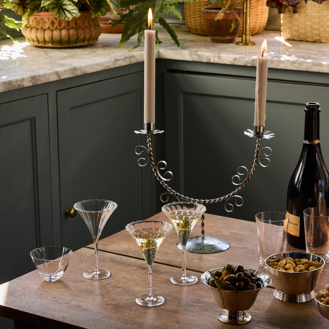 a wooden table topped with wine glasses and a bottle of wine