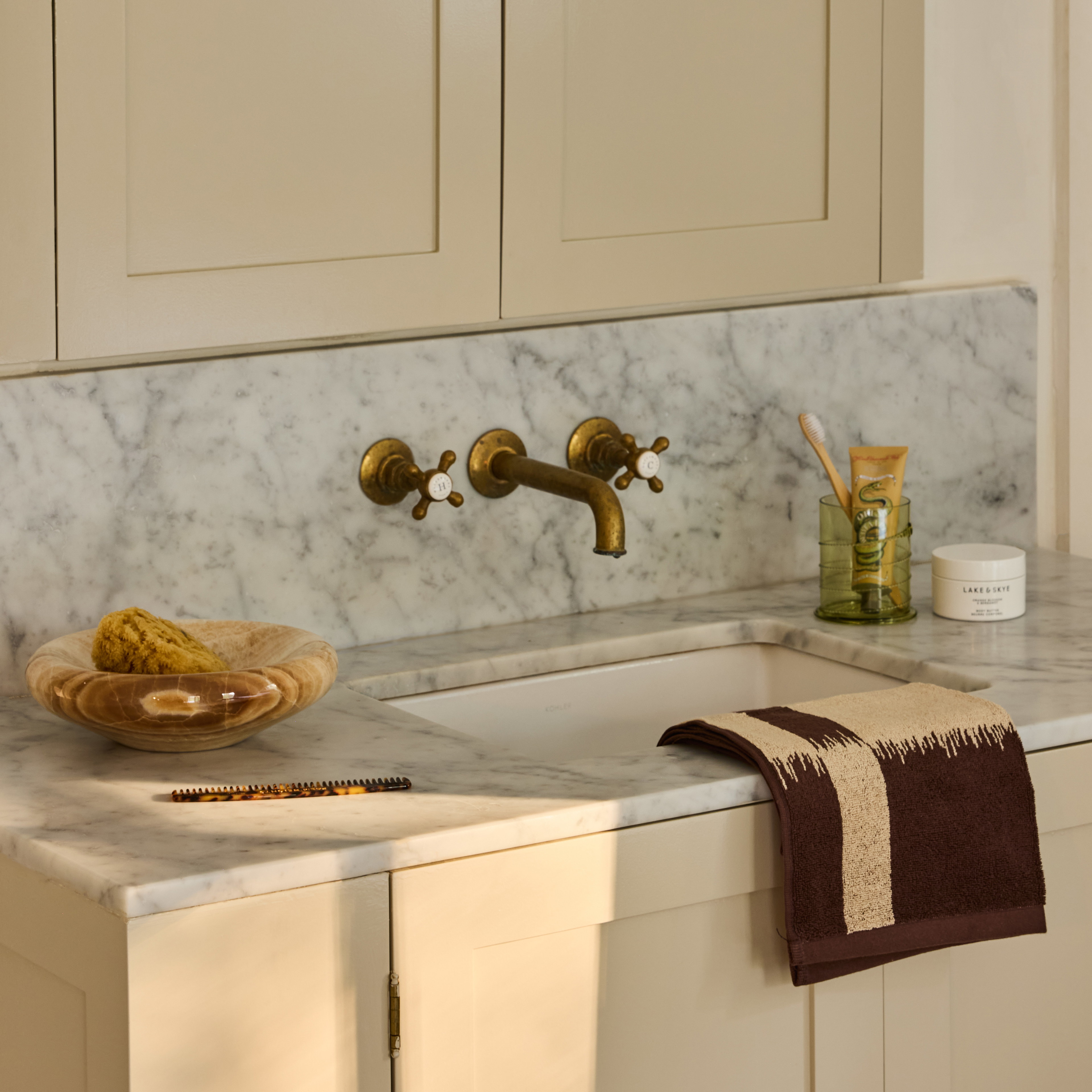 a kitchen with a marble counter top and white cabinets