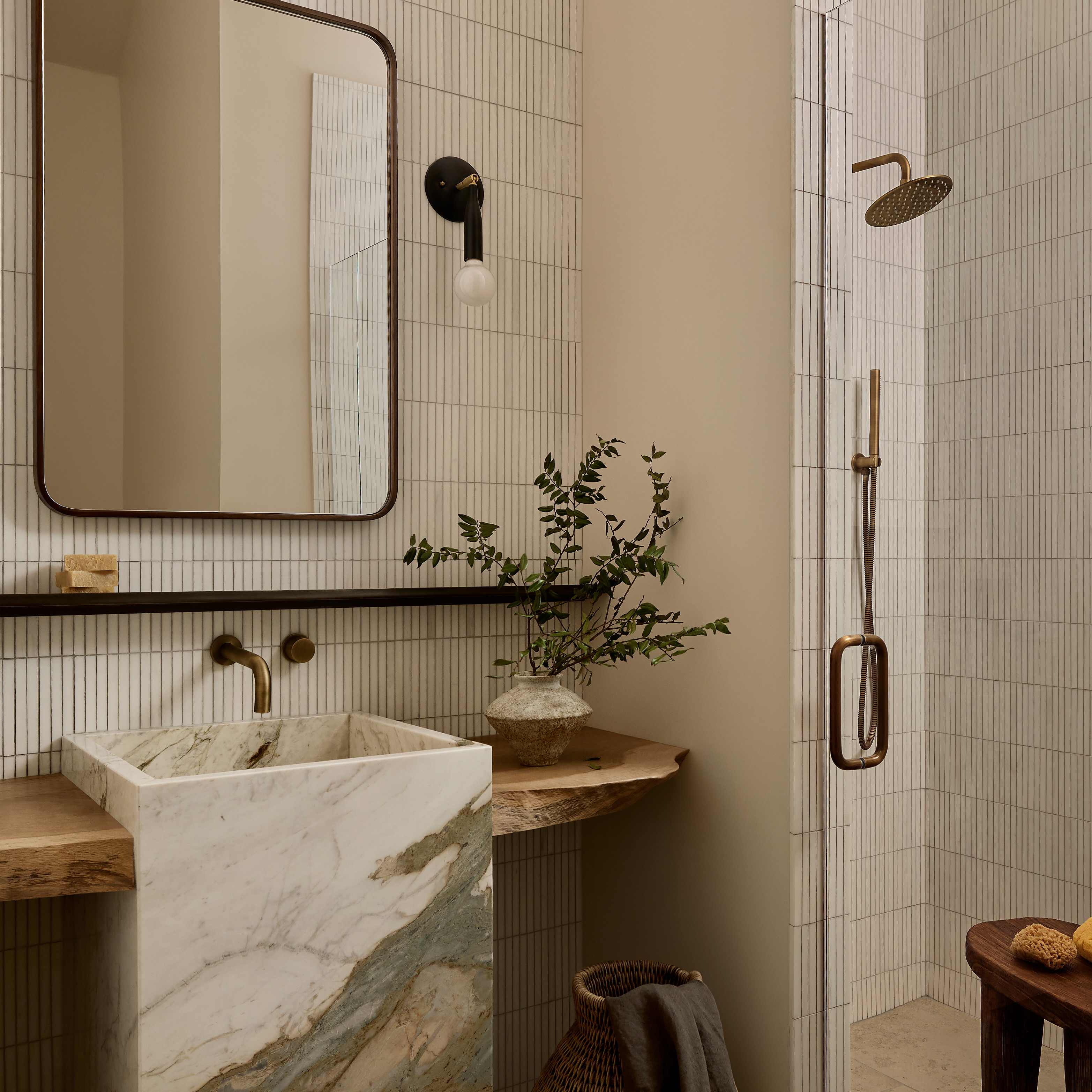 a bathroom with a marble sink and a large mirror