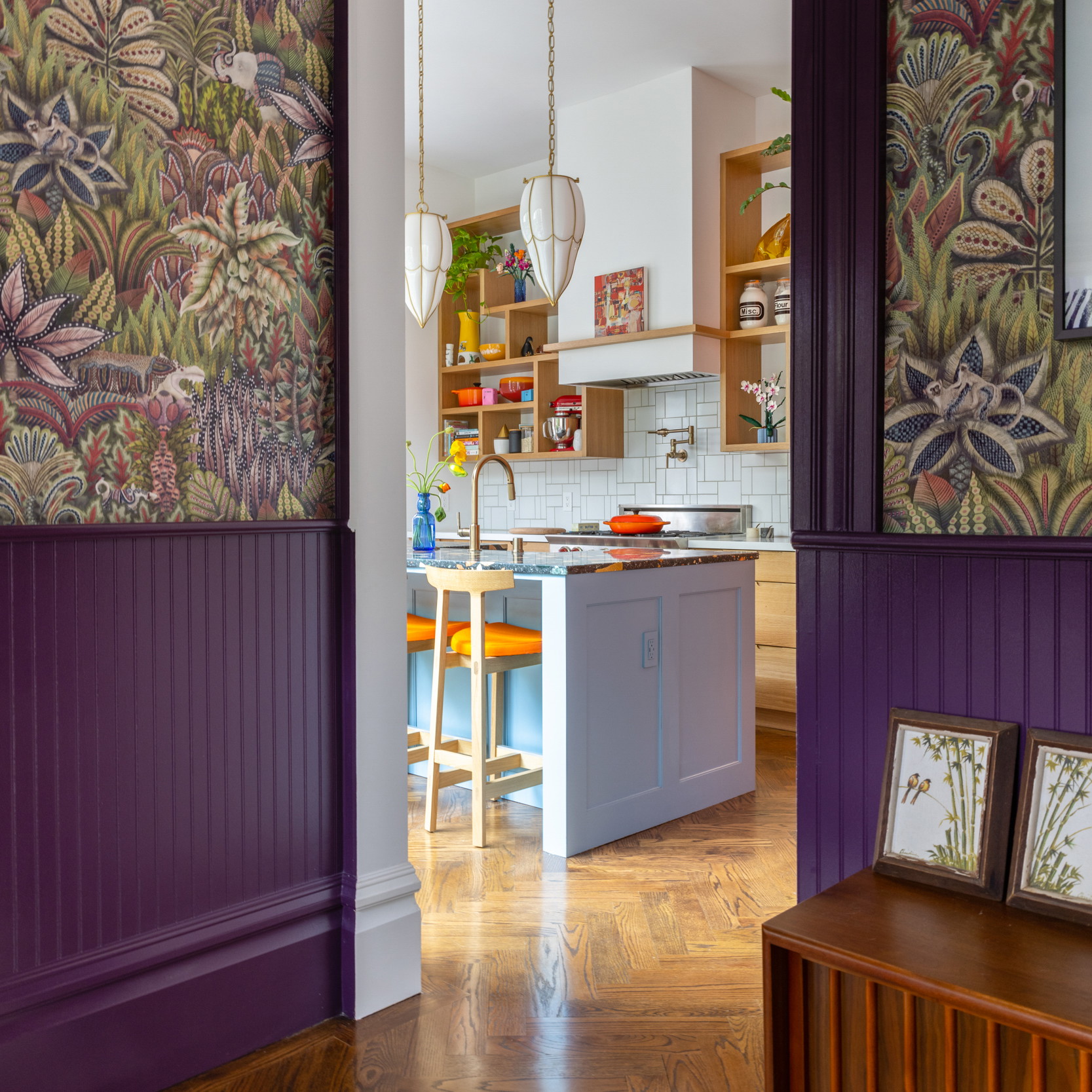 a kitchen and dining room with purple walls